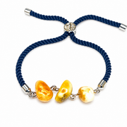 Three irregular amber beads and silver-tone links of KIZIMA 3P0400q4.79 isolated on pure white