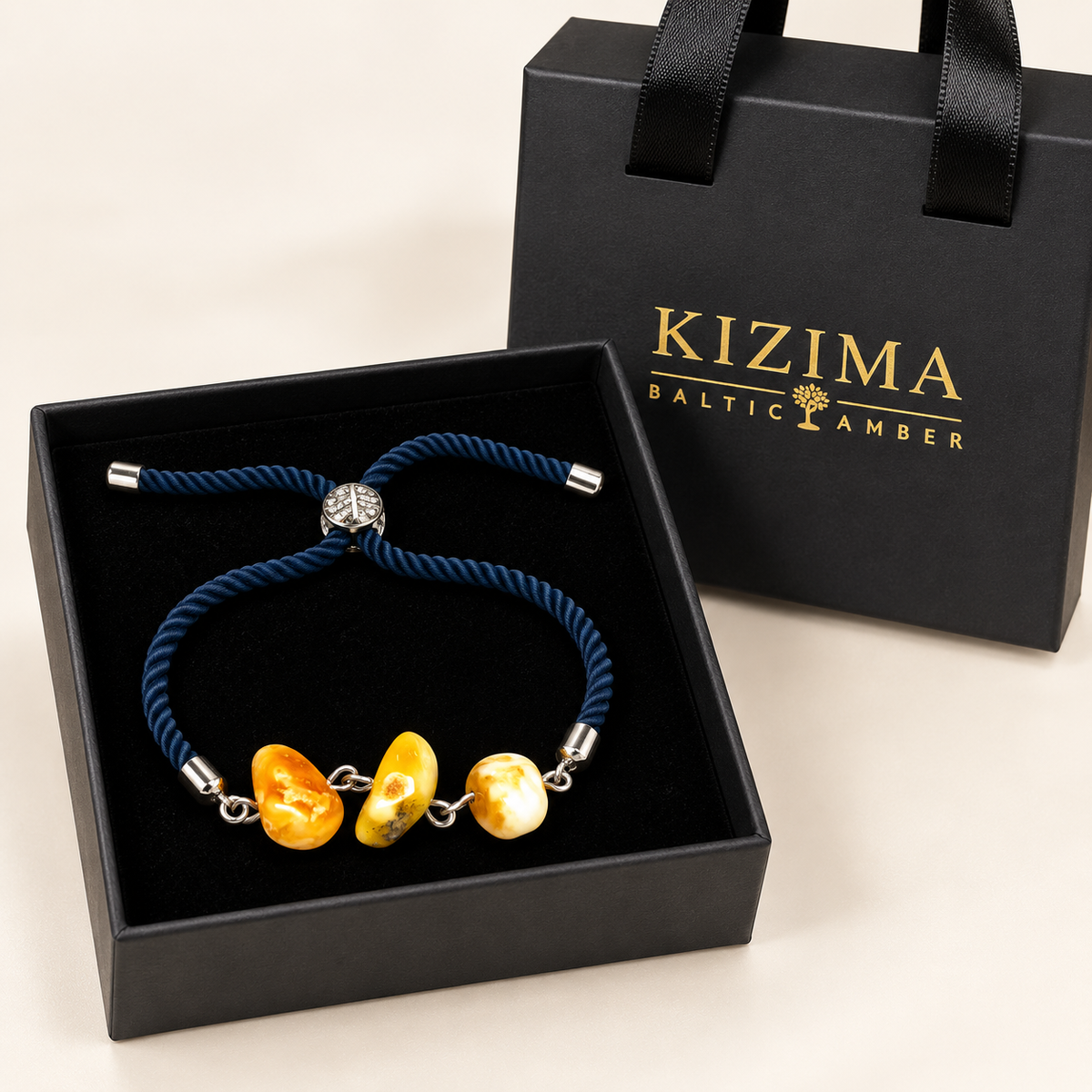 KIZIMA 3P0400q4.79 amber navy cord bracelet resting in its black KIZIMA gift box