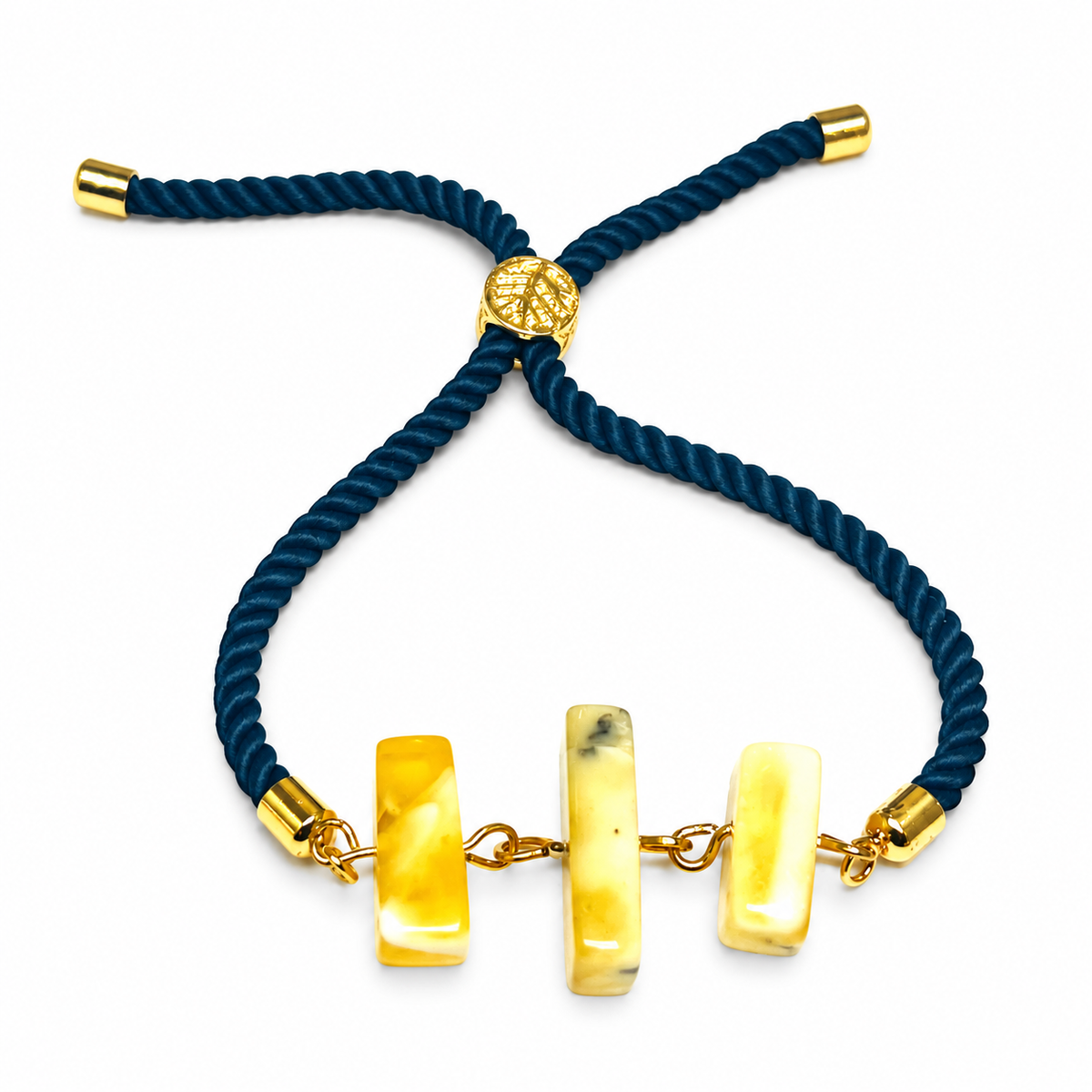 Three rectangular amber bars with gold-tone links, teal twisted cord and an adjustable slider on white