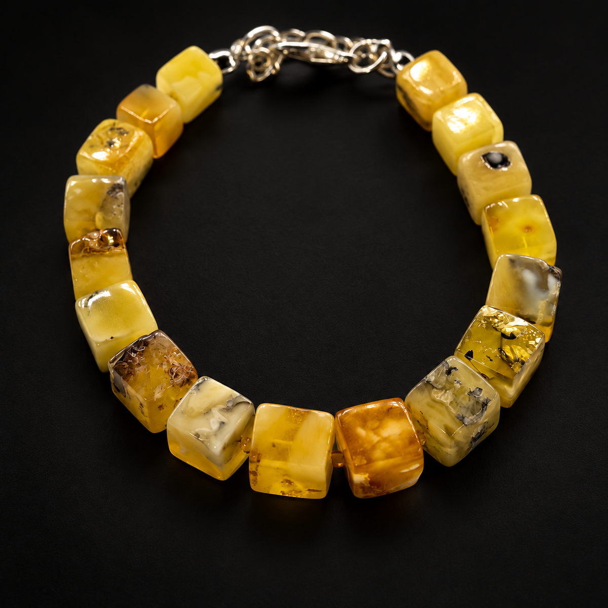 KIZIMA yellow amber cuboid bead bracelet with silver-tone clasp on a black studio background.