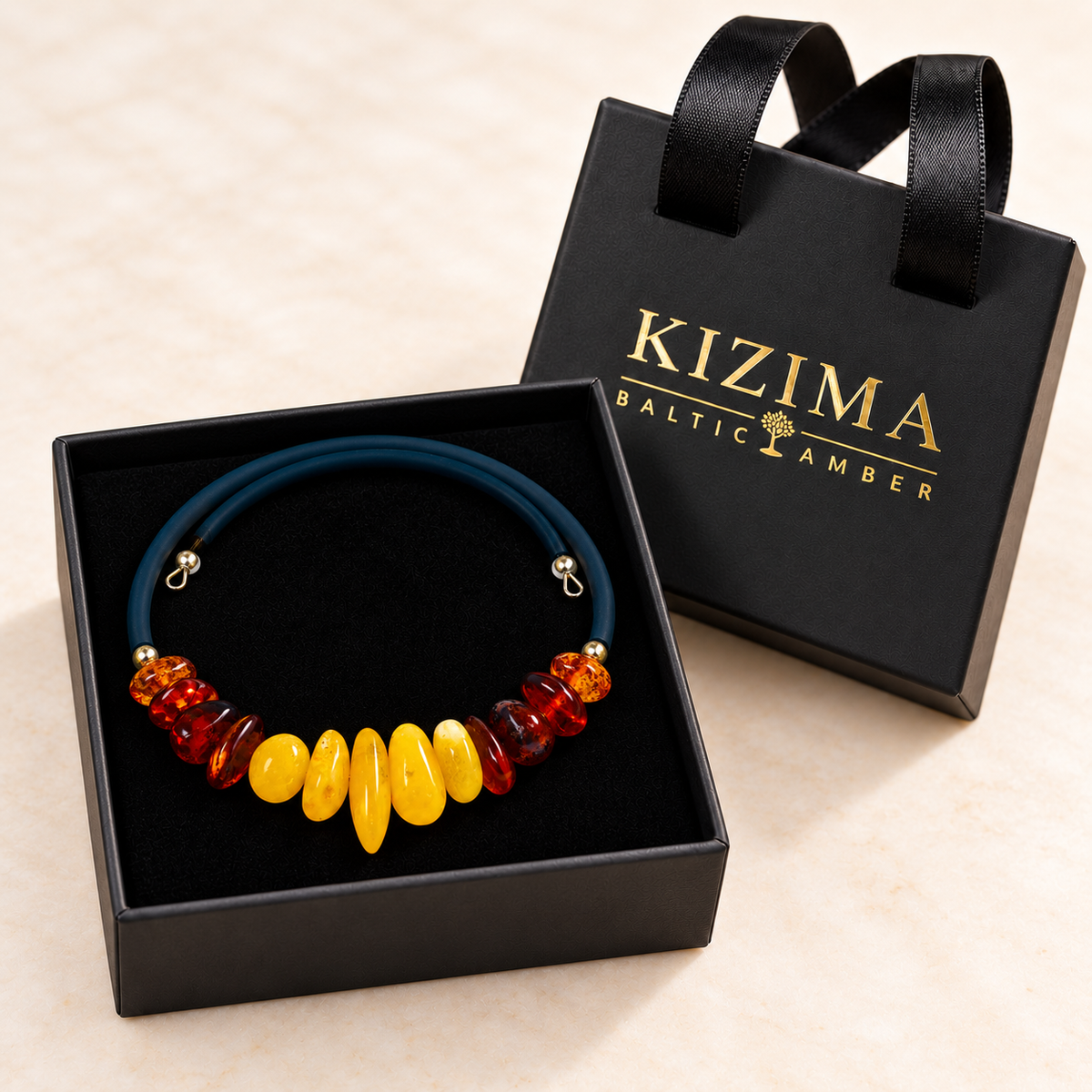 KIZIMA thirteen-stone yellow and cognac amber open wrap bracelet in a black KIZIMA gift box.