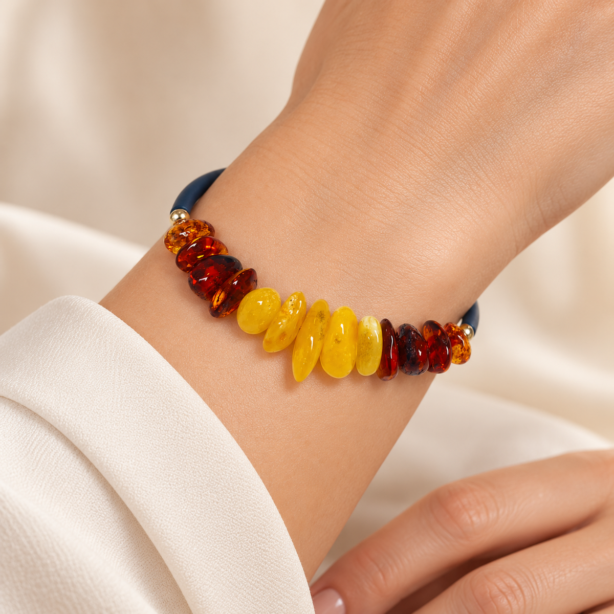 KIZIMA thirteen-stone yellow and cognac amber open wrap bracelet worn on a young adult woman's wrist.