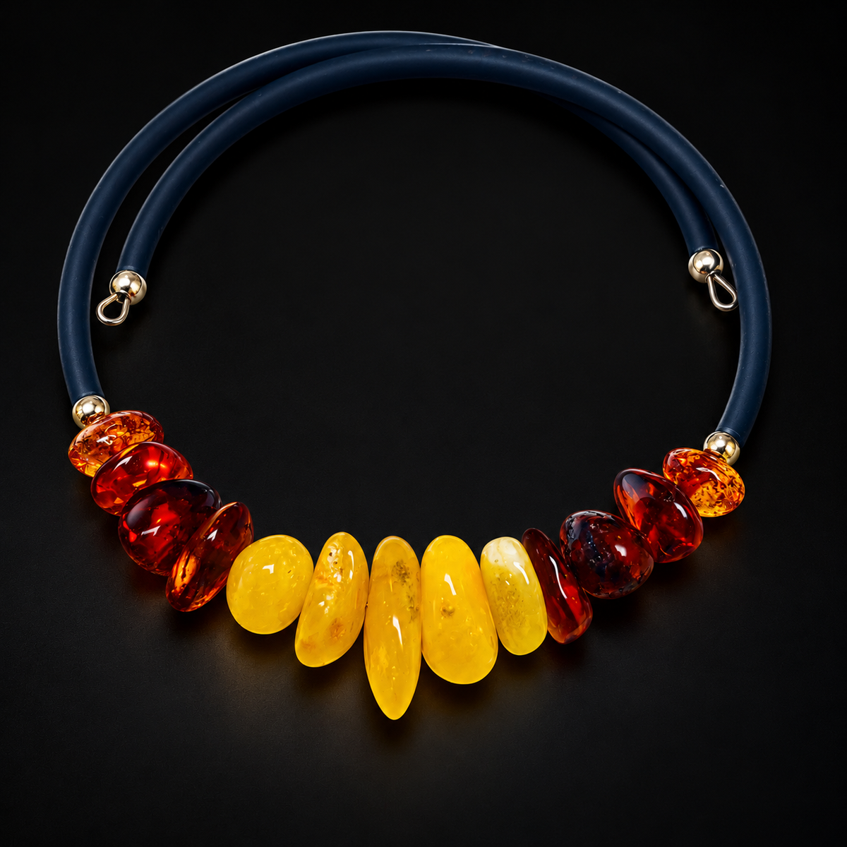 KIZIMA thirteen-stone yellow and cognac amber open wrap bracelet on a black studio background.
