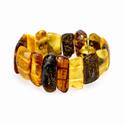 Polished yellow, cognac and dark amber panels forming a wide stretch bracelet on pure white.
