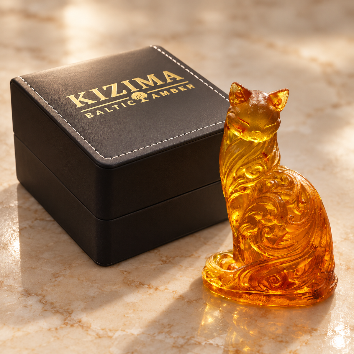 KIZIMA cat figurine beside the actual black stitched branded gift box