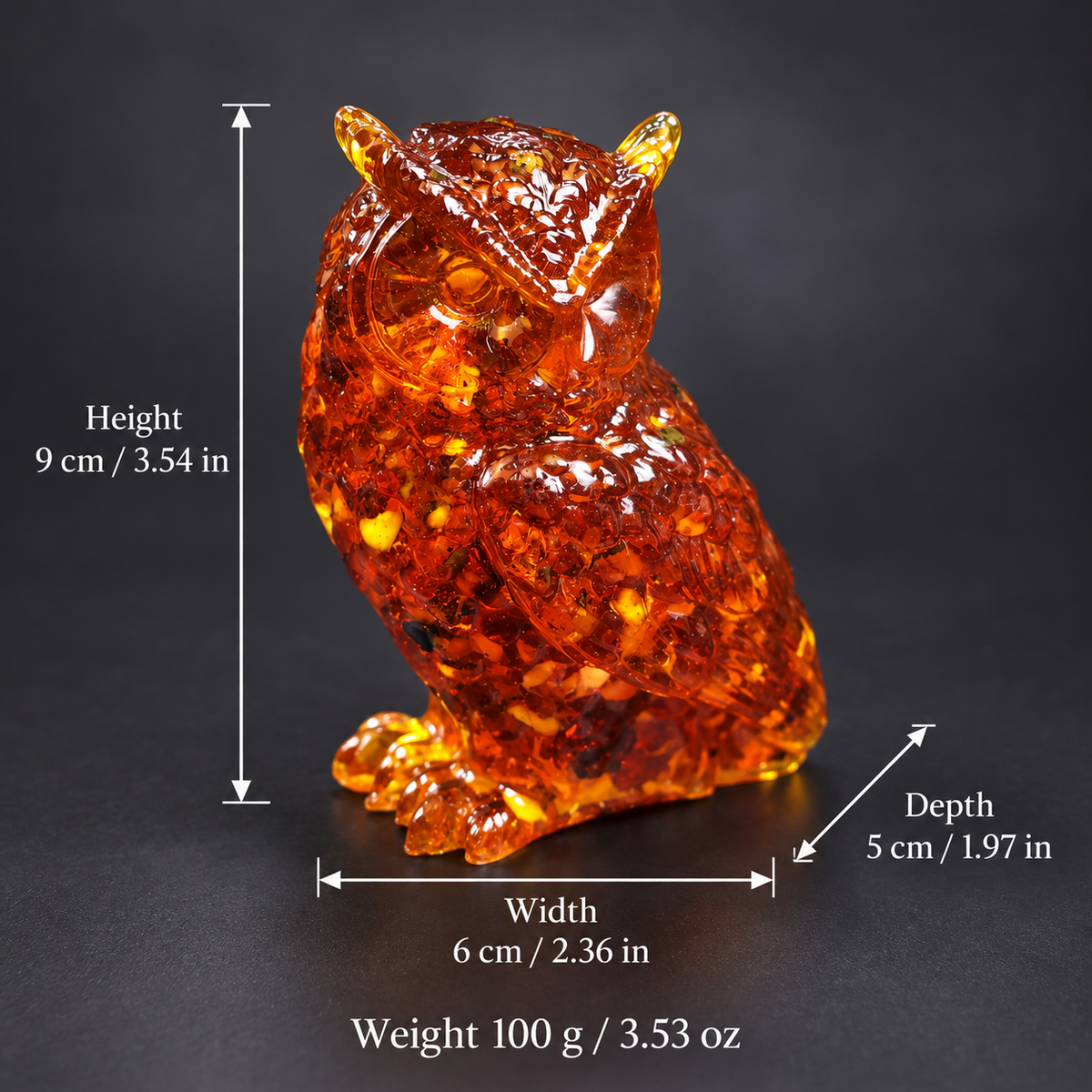 Amber owl with measurement arrows showing 9 cm height, 6 cm width, 5 cm depth and 100 g weight, with inch and ounce conversions.