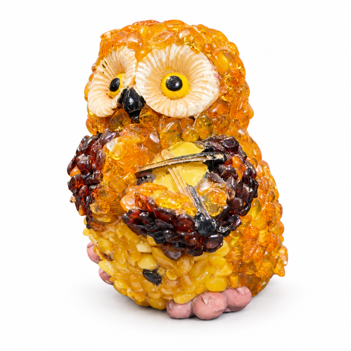 Three-quarter view of the handmade Baltic amber violinist owl on a white background.