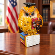 Made in USA natural Baltic amber scholar owl reading a red book, on an office desk with a U.S. flag.
