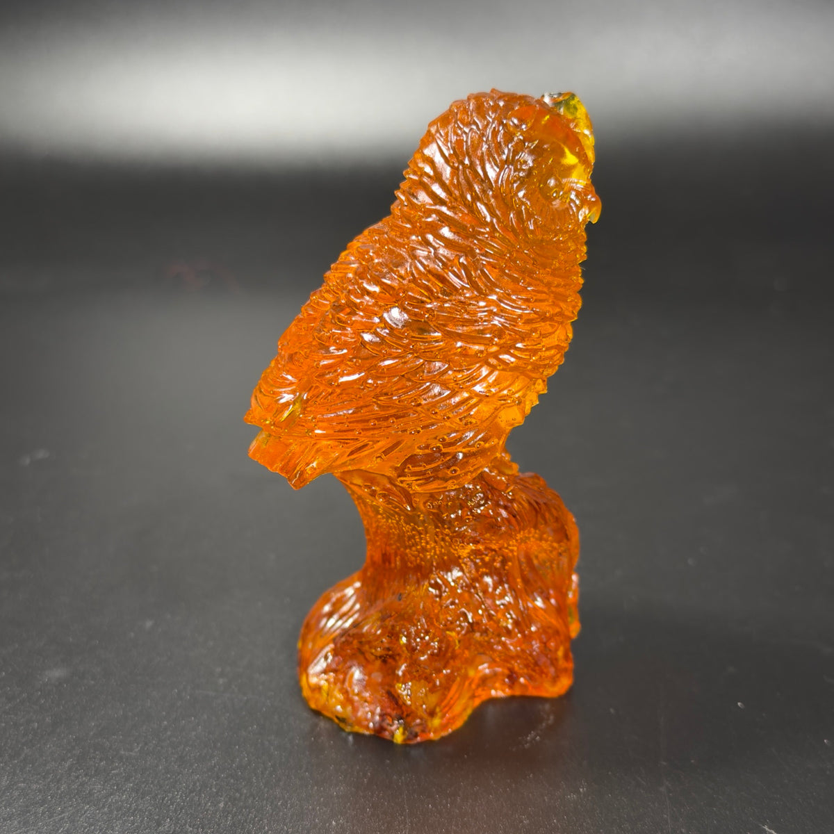 Original side profile of the orange owl showing the wing and tail carving
