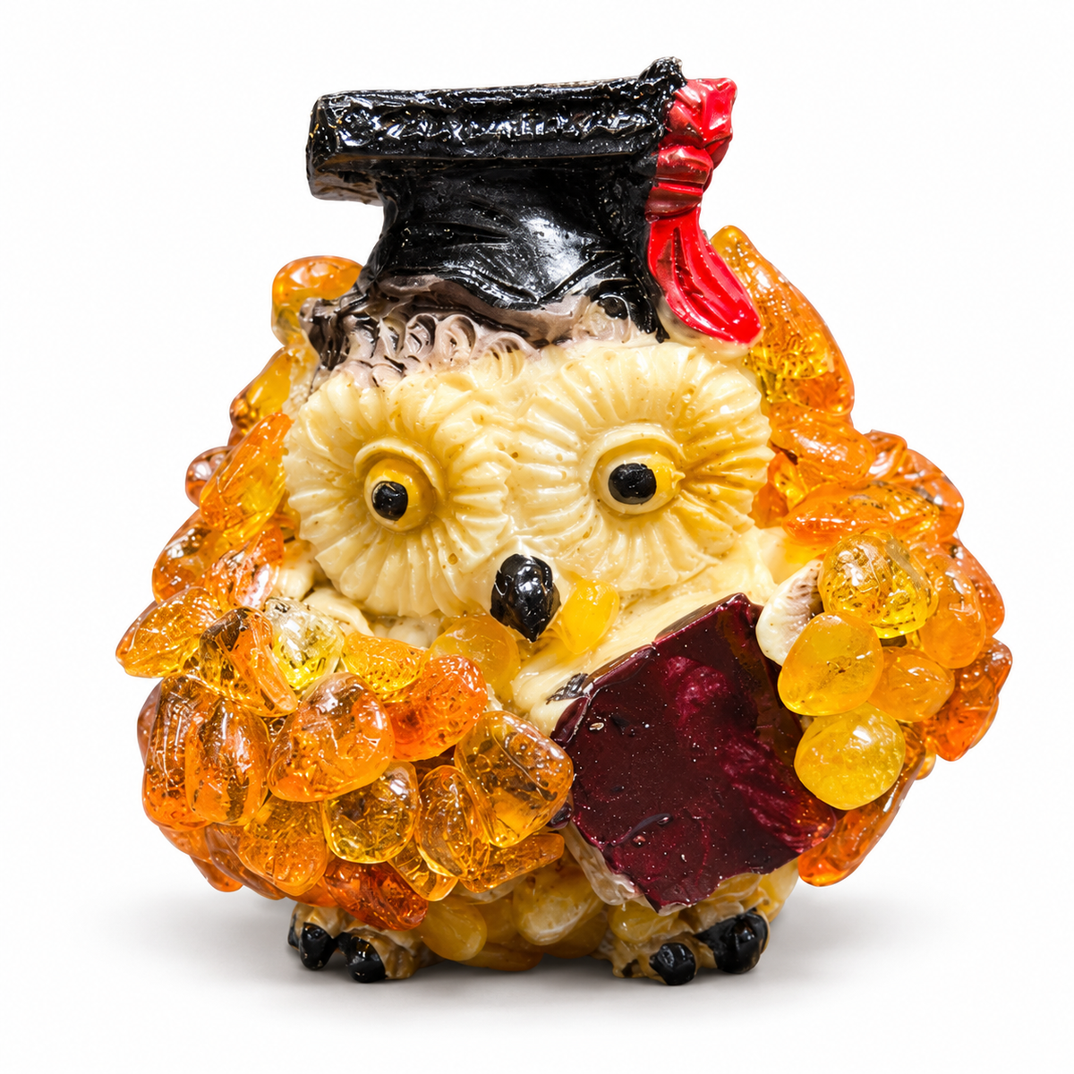 Front view of graduation owl with black cap and red tassel on white