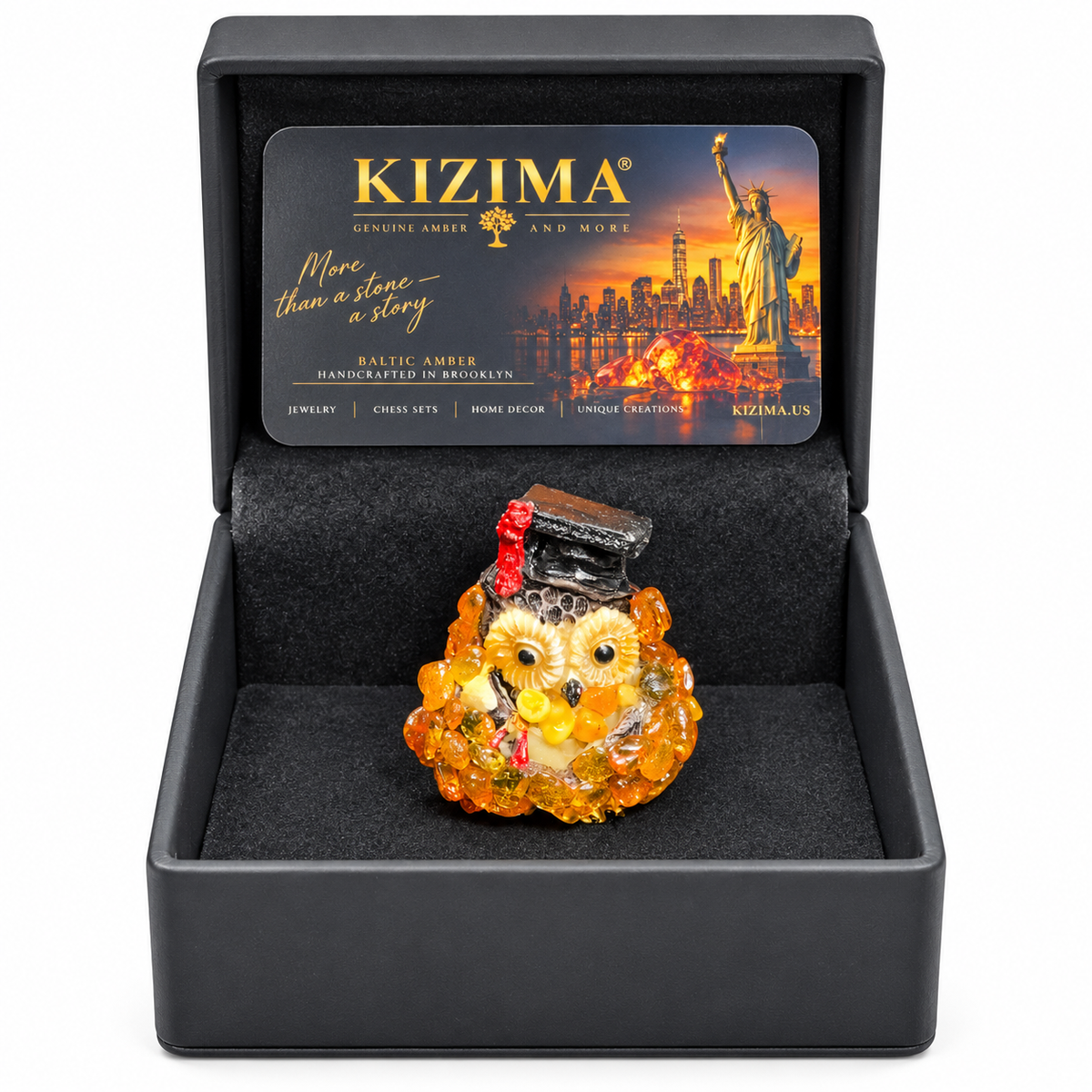 Graduation owl inside its open black gift box with KIZIMA card on white
