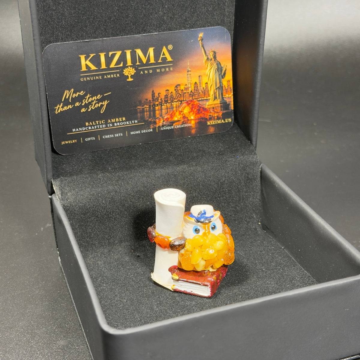 Original photograph of owl figurine inside black KIZIMA presentation box