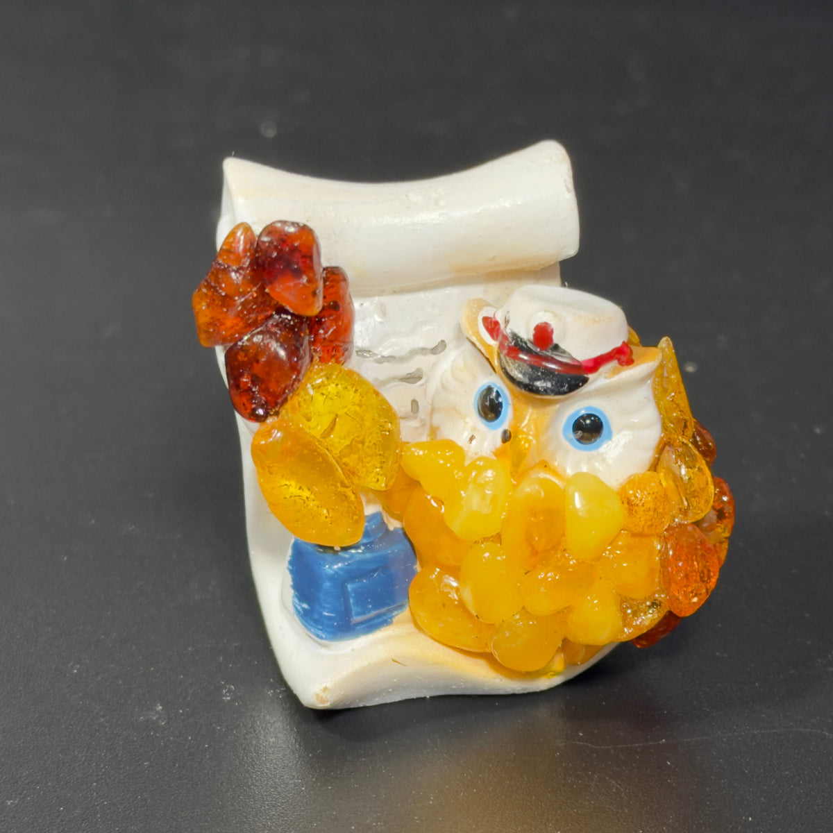 Original photograph of the blue-eyed capped owl figurine and cream scroll backing