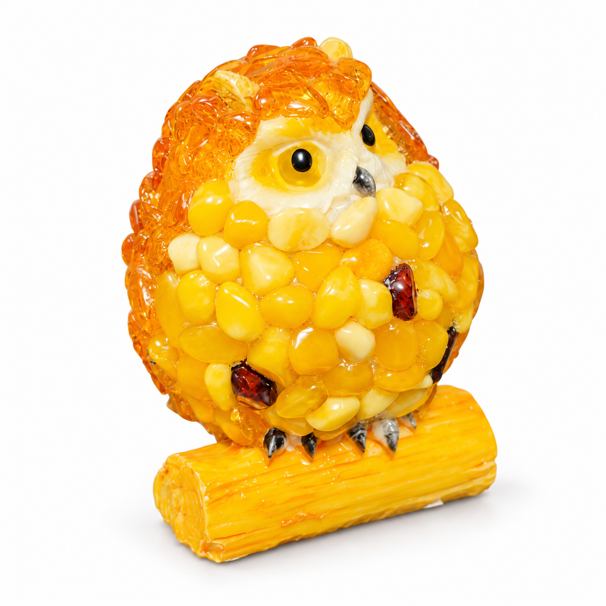 Three-quarter view of the yellow and orange owl figurine on a white background