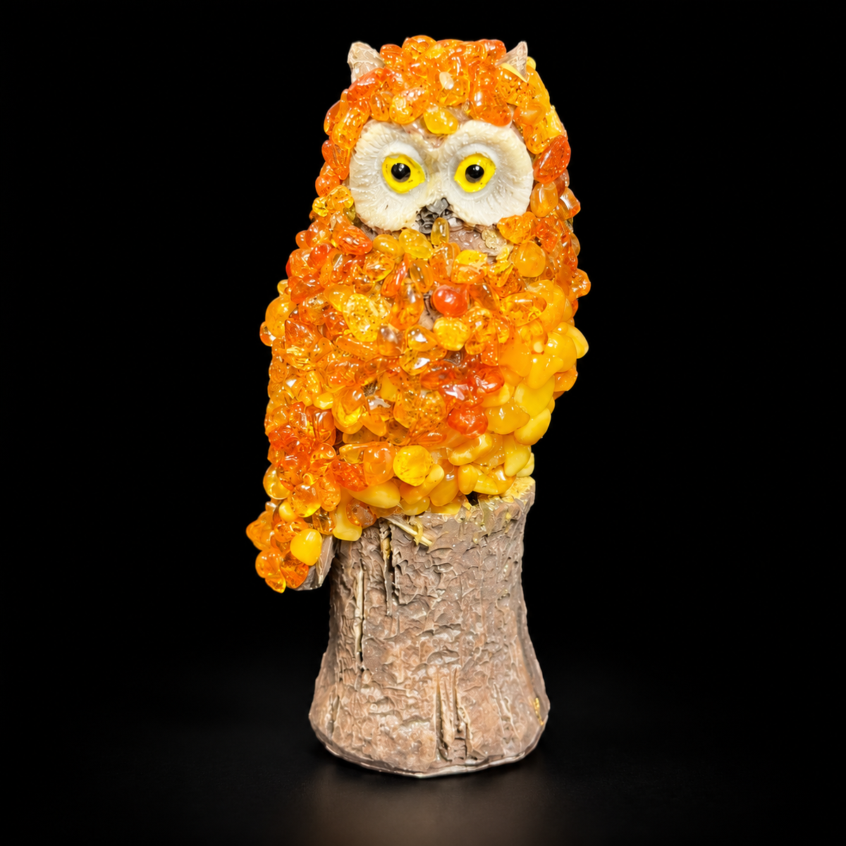 Made in USA natural Baltic amber owl on a carved tree stump, orange and golden mosaic, black studio background