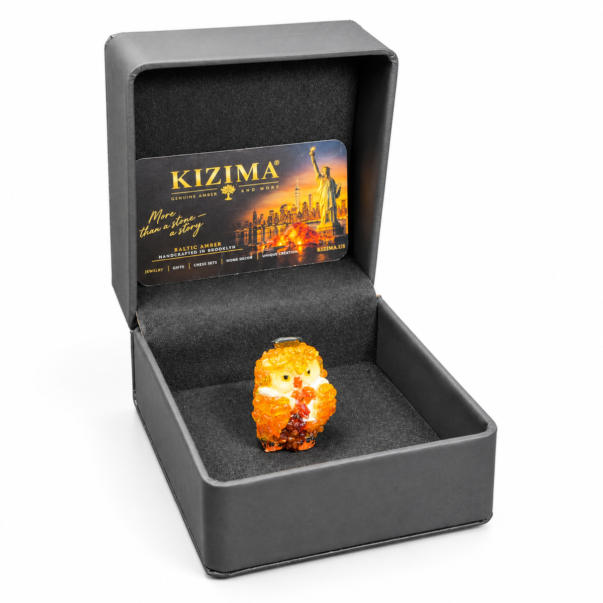 Owl figurine inside its open charcoal KIZIMA presentation box