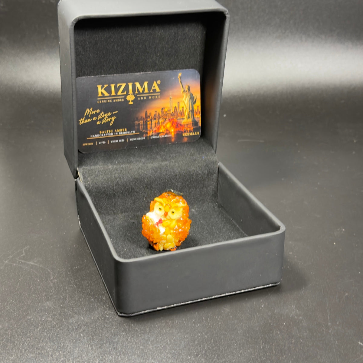 Original photograph of the graduation owl in the KIZIMA presentation box