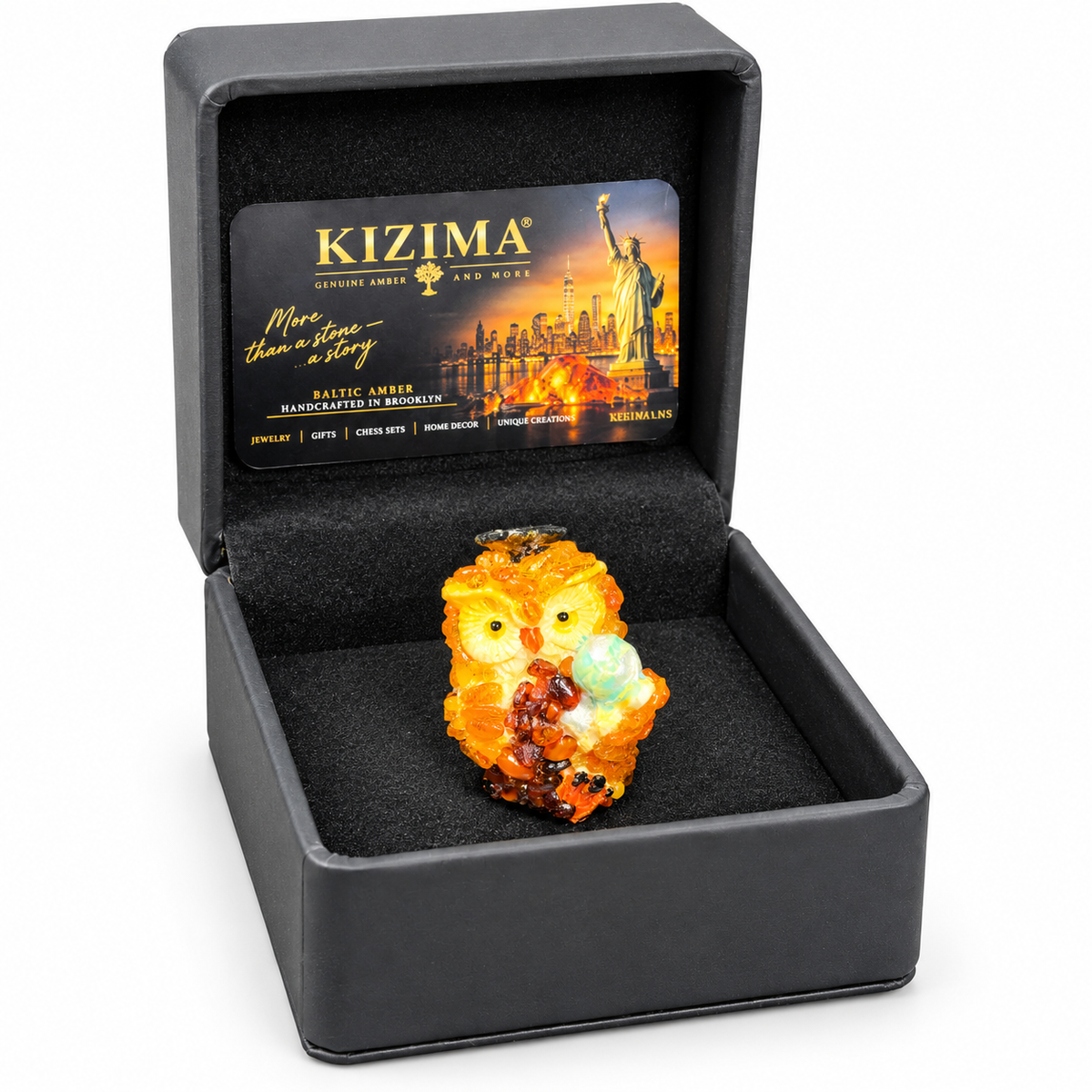 Globe owl figurine in its open charcoal KIZIMA presentation box on white