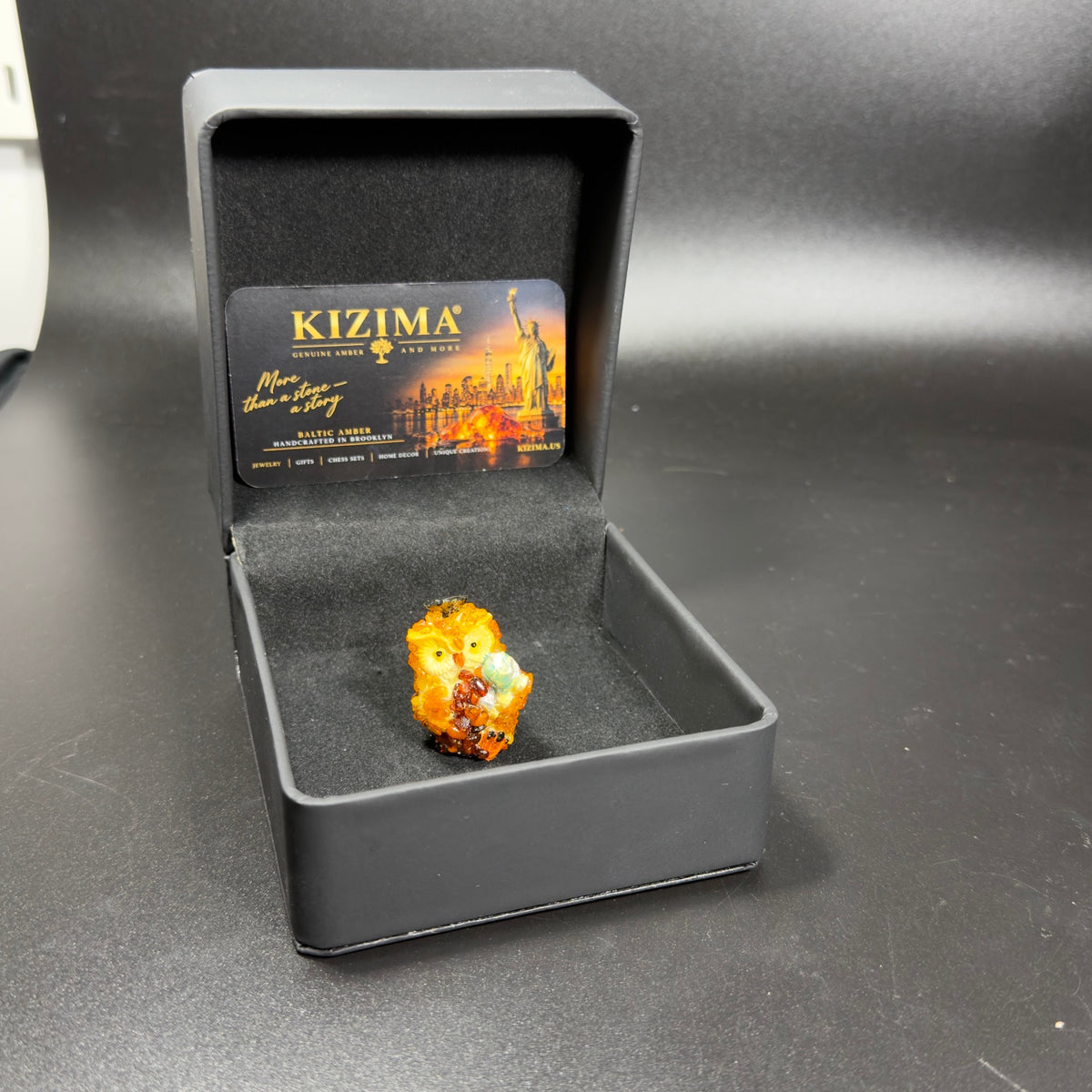 Original photograph of globe owl in its open KIZIMA presentation box