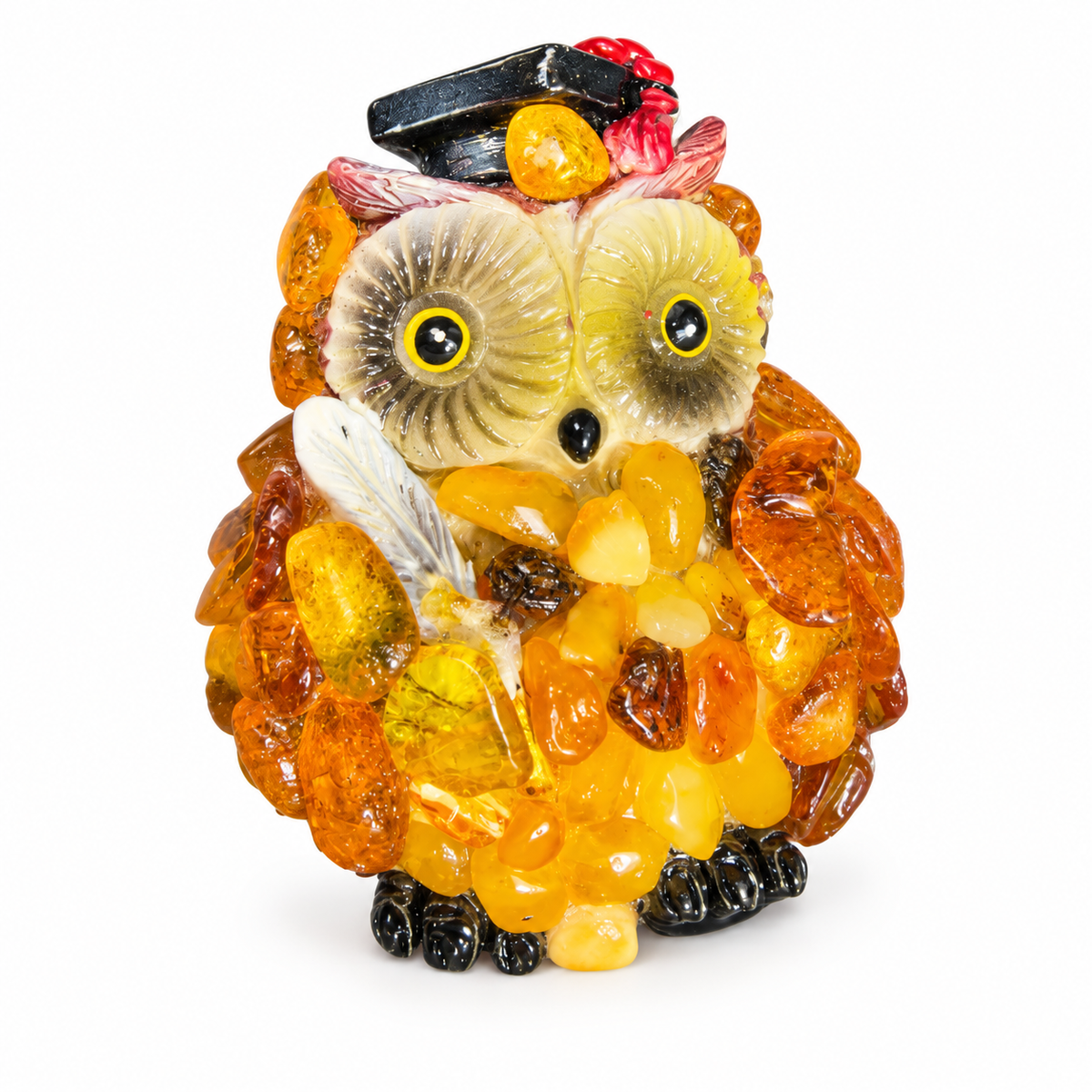 Close-up of handmade amber owl magnet with red tassel cap, cream face and honey amber mosaic, white background