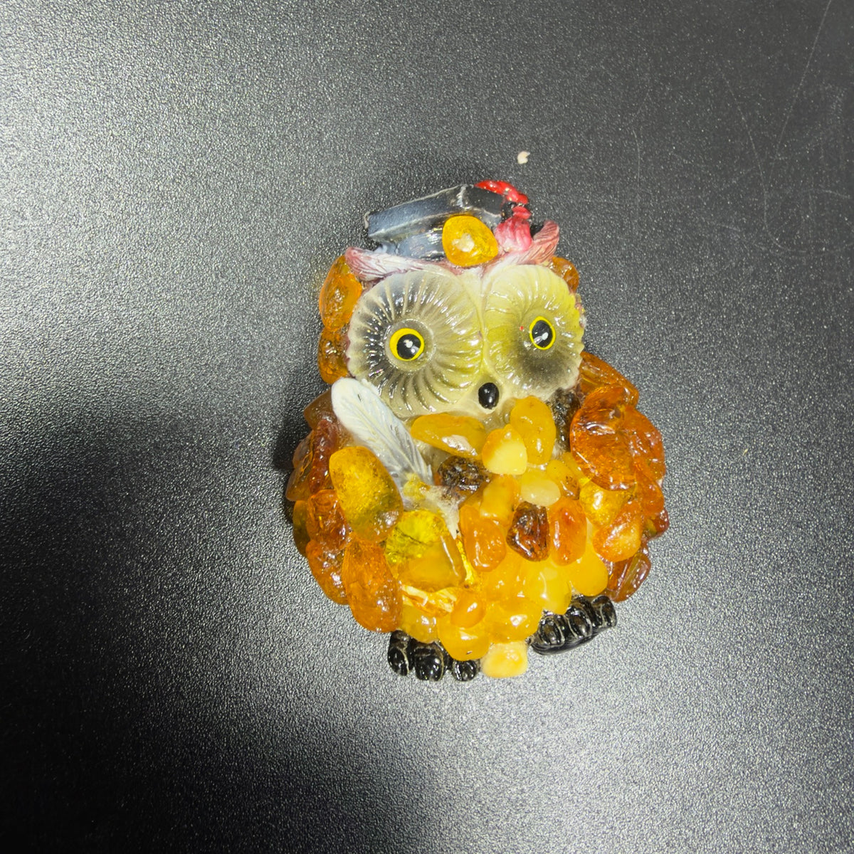 Unedited workshop photo of the amber mosaic graduation owl magnet with cap and quill