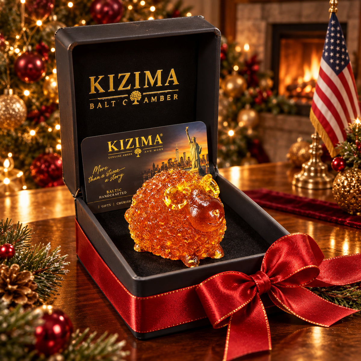 Round amber ram with spiral fleece and curled yellow horns inside a black KIZIMA box with red satin ribbon, against a Christmas tree, fireplace and American flag.