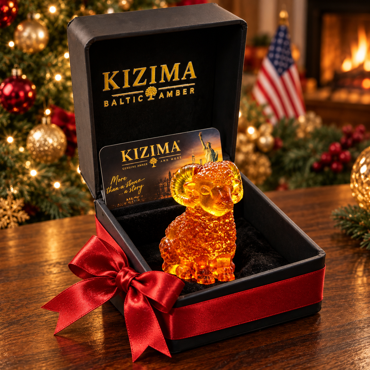 Amber ram in an open black KIZIMA gift box with a red satin bow, with a Christmas tree, American flag and fireplace in the background.
