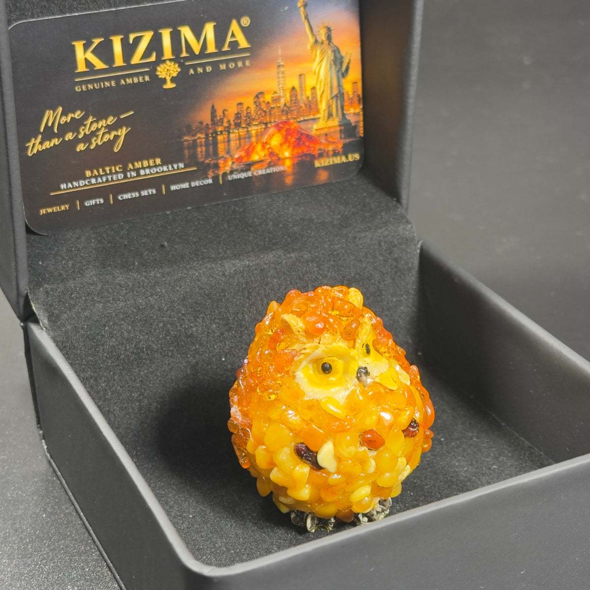 Original photograph of the orange and yellow owl figurine with its KIZIMA box