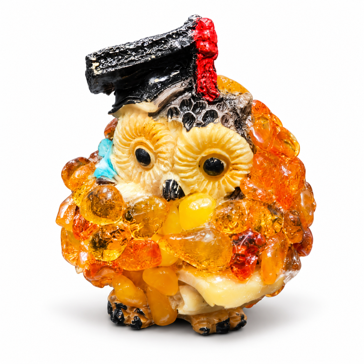 Front view of the golden-orange graduation owl figurine on a white background