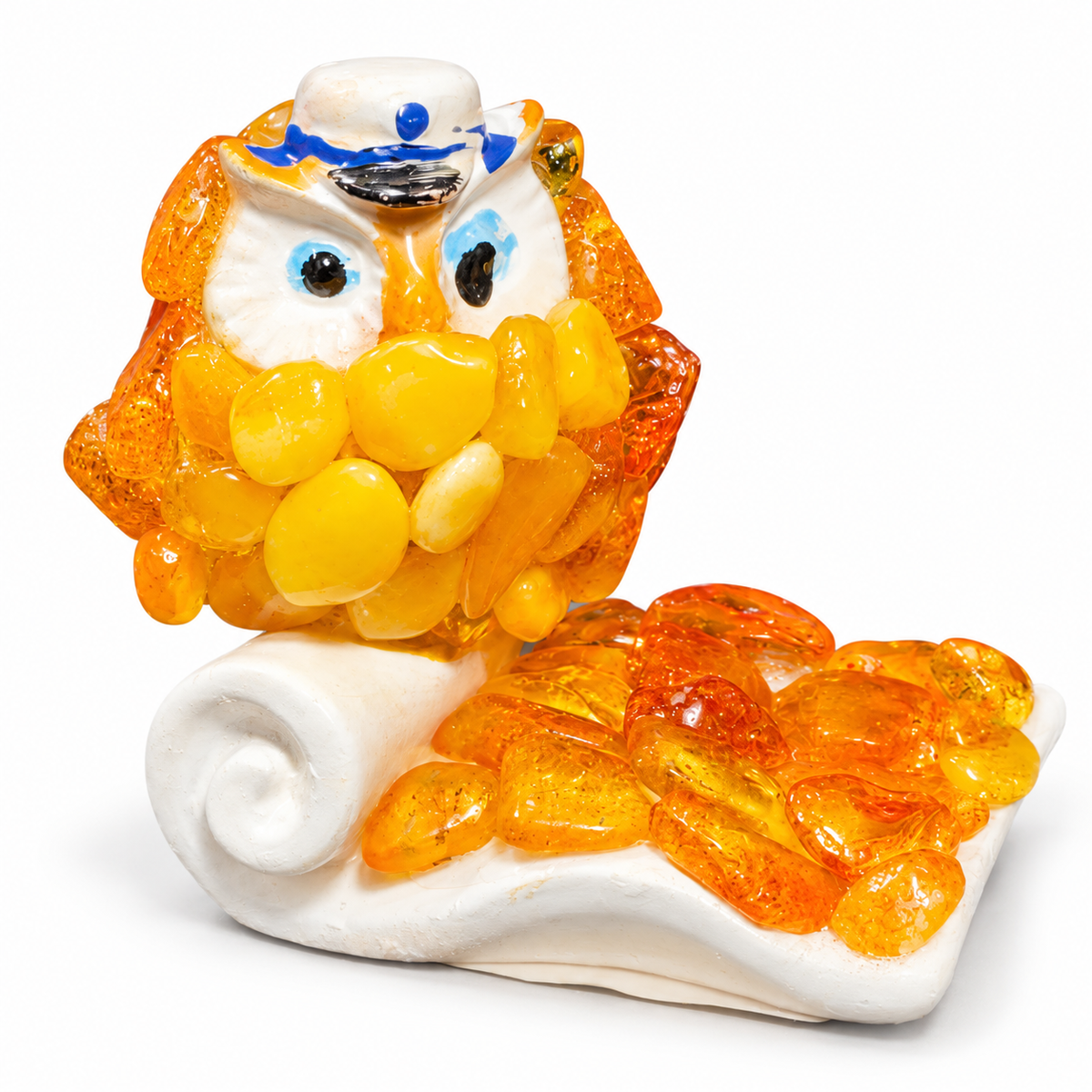 KIZIMA owl figurine with golden-orange chips and white scroll base on a clean white background