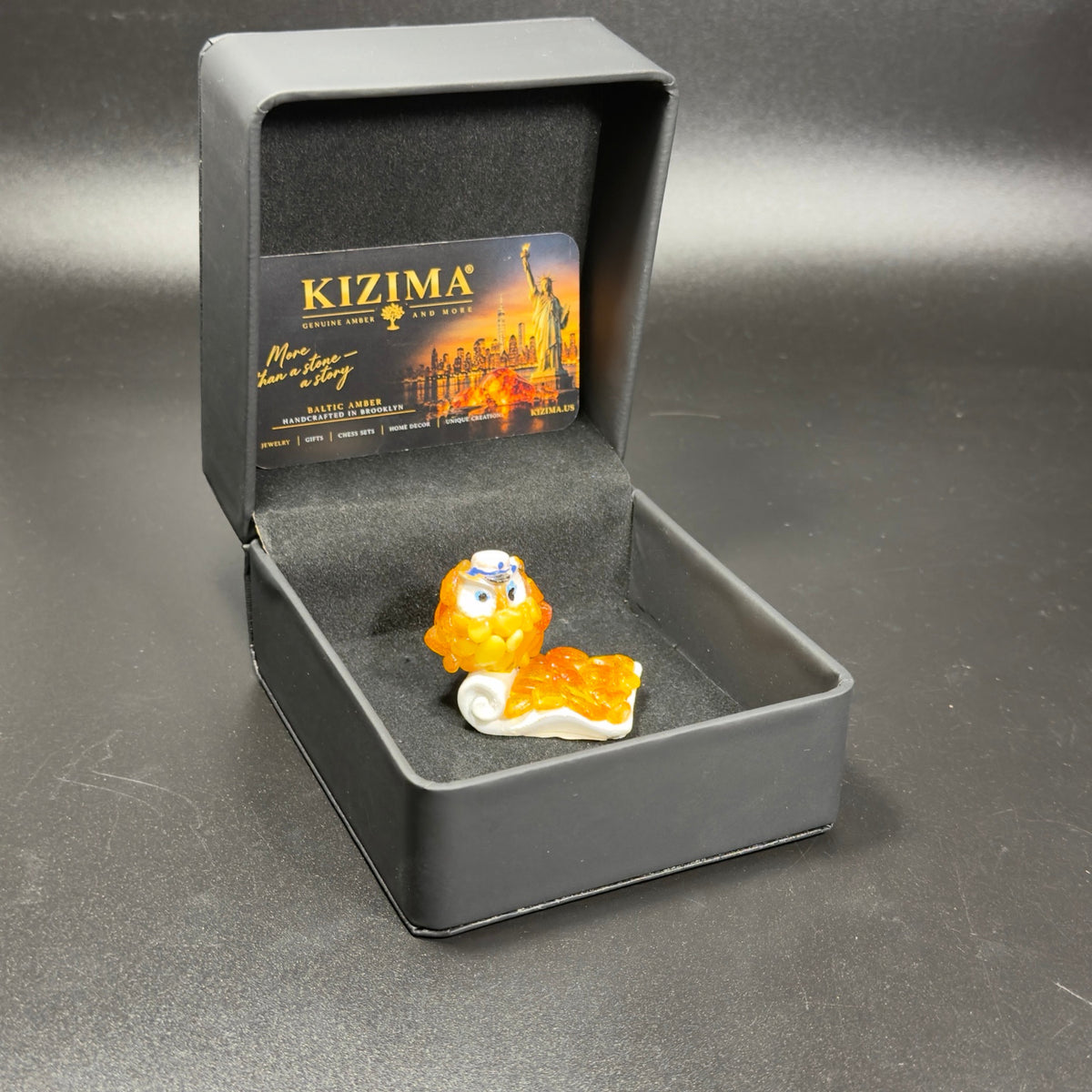 Original photo of the owl figurine inside its KIZIMA box with black insert and branded card
