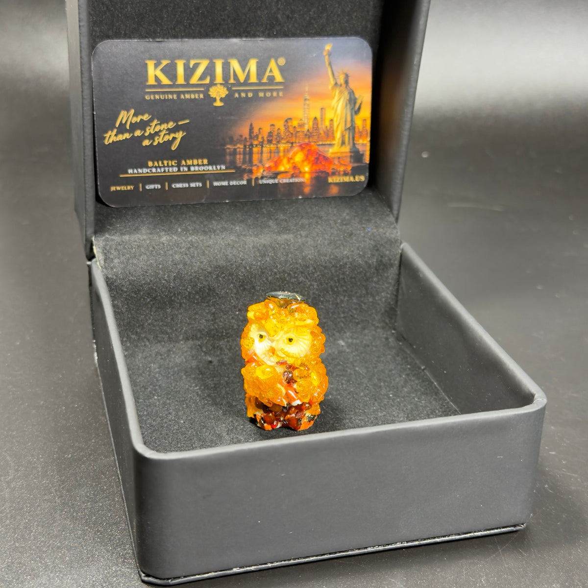 Original photograph of the graduation owl figurine and its box.