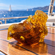 KIZIMA Mini mermaid in shell 53A002q30 on a teak yacht table with blue sea in the background.