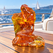 KIZIMA Mermaid on sea wave figurine 53Mermaidq140-2.5-3.5-4.5 on a teak yacht table with blue sea in the background.