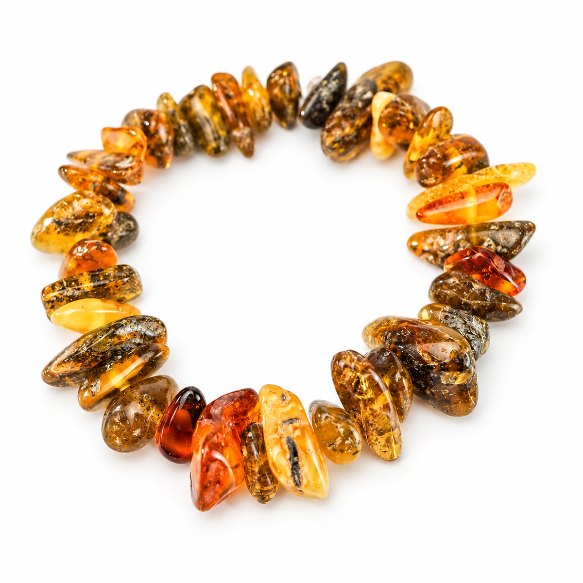 Irregular honey, cognac and olive amber nuggets with dark inclusions on pure white.