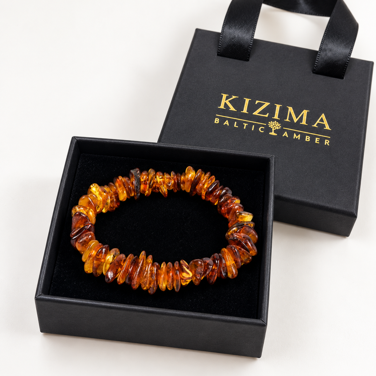 KIZIMA polished honey and cognac amber chip bracelet in a KIZIMA gift box.