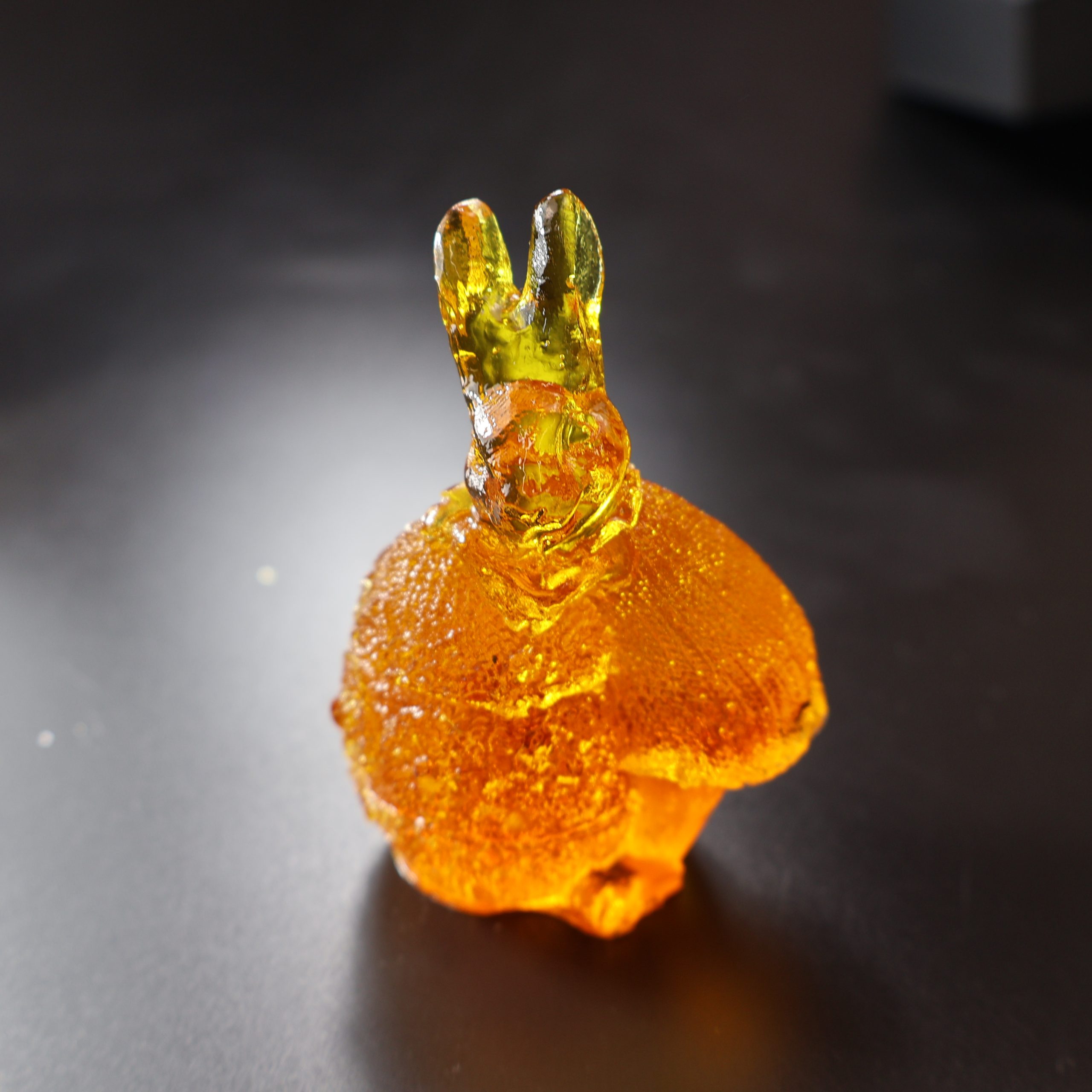 KIZIMA® bunny on egg amber figurine — genuine Baltic amber decor, handmade in USA, side view