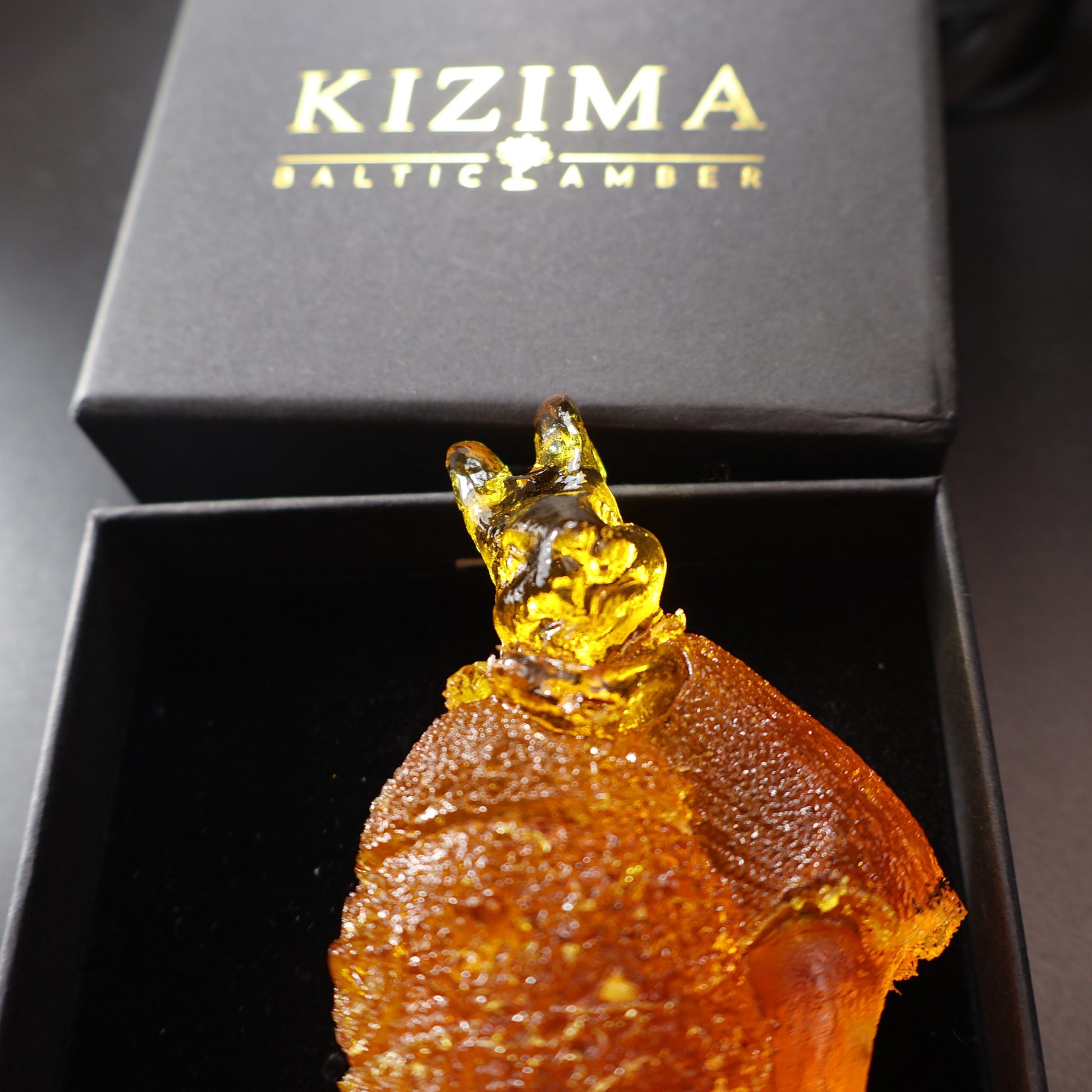 KIZIMA® handmade amber bunny on egg — natural Baltic amber decor, USA, side angle
