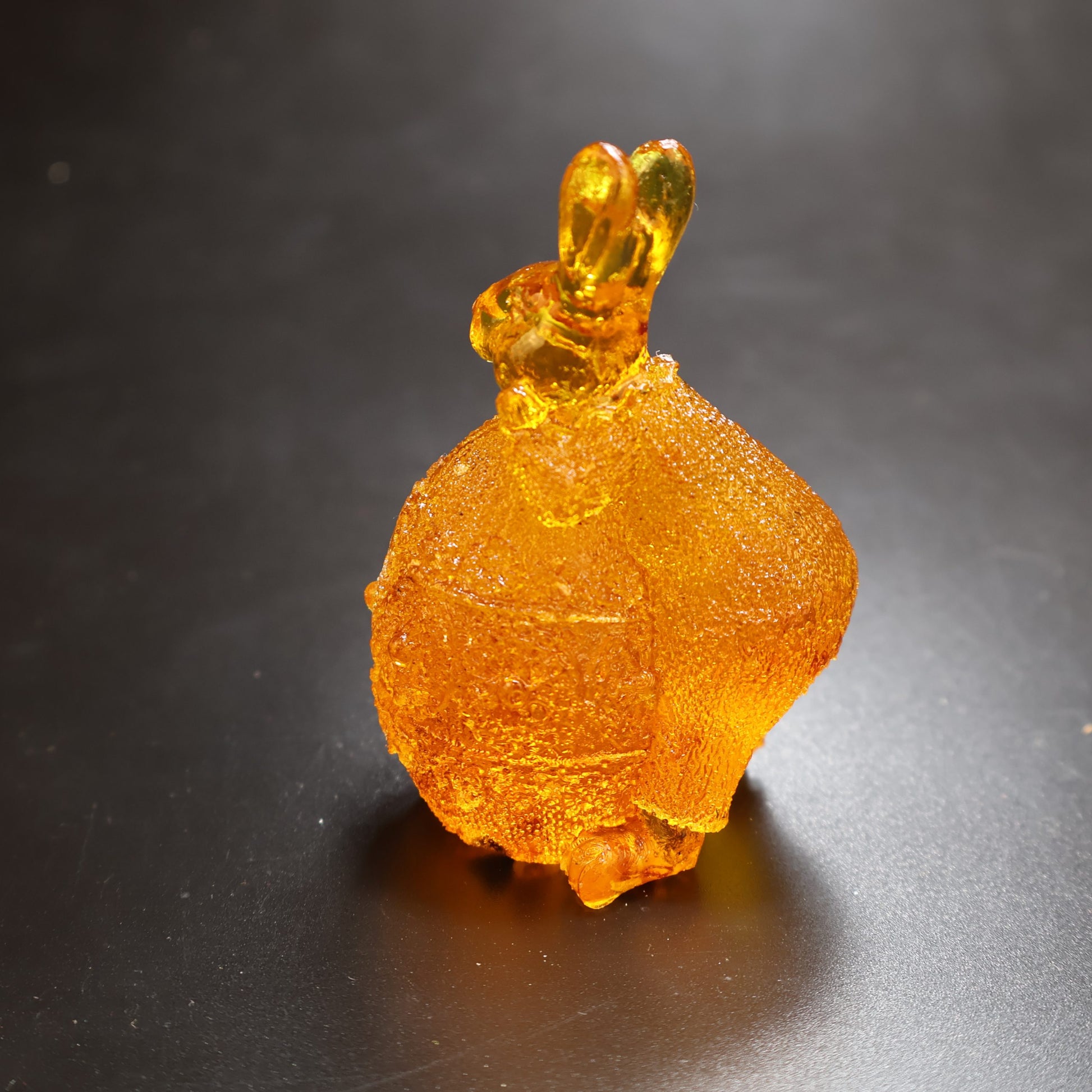 Handmade Baltic amber bunny on egg by KIZIMA® USA — natural amber decor, close-up