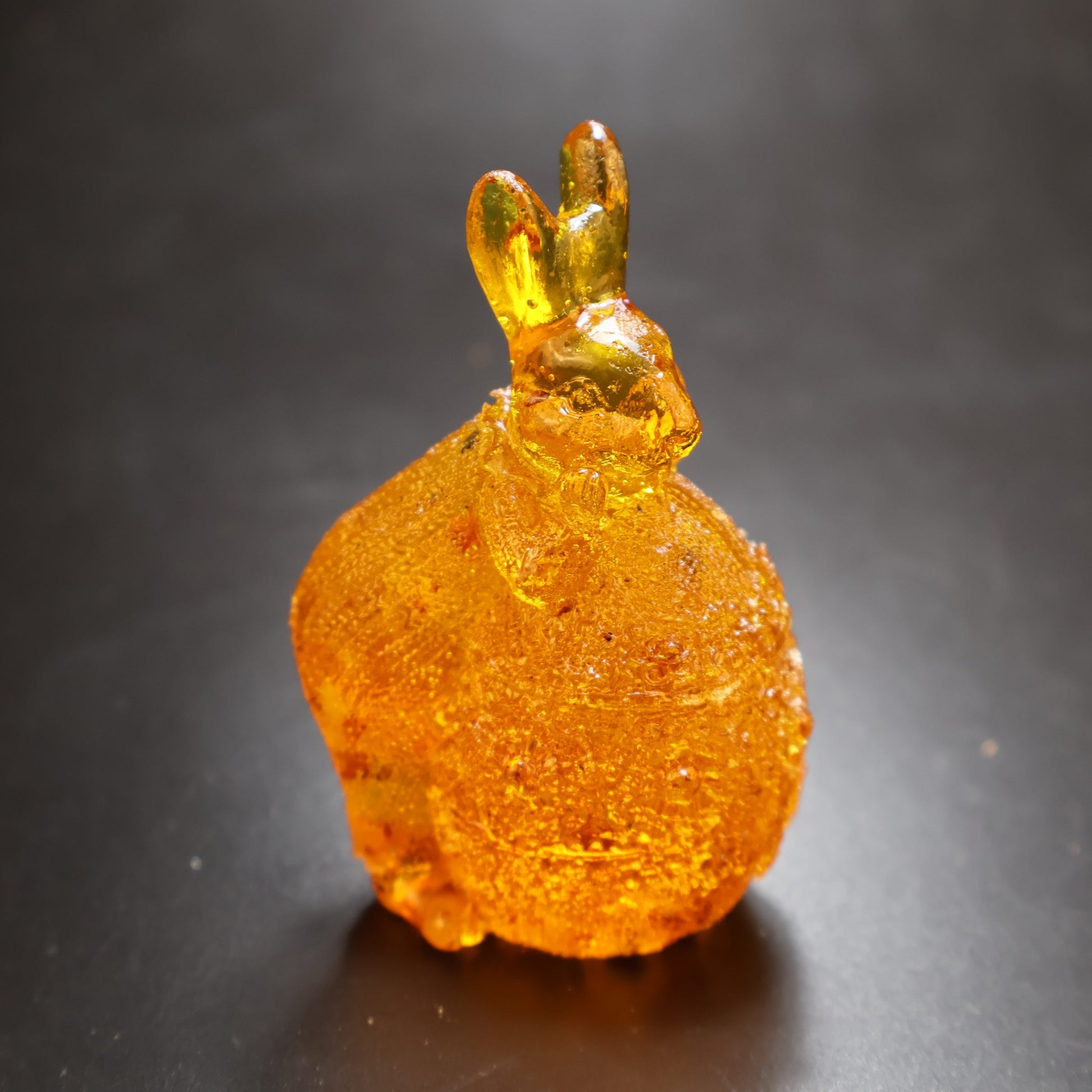 KIZIMA® amber bunny on egg figurine — genuine Baltic amber decor, made in USA, side view