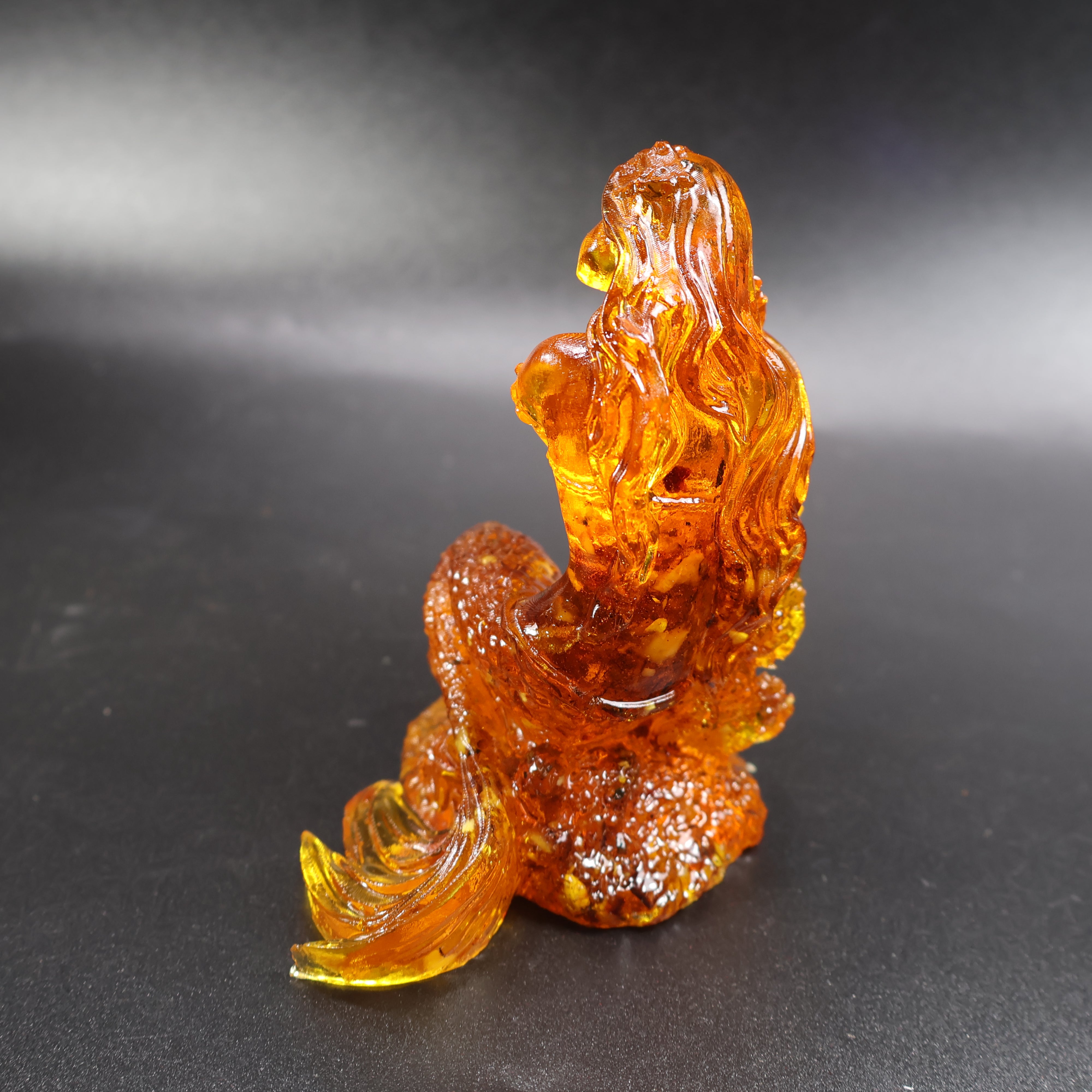 Close-up of golden Baltic amber mermaid on wave, KIZIMA® craftsmanship
