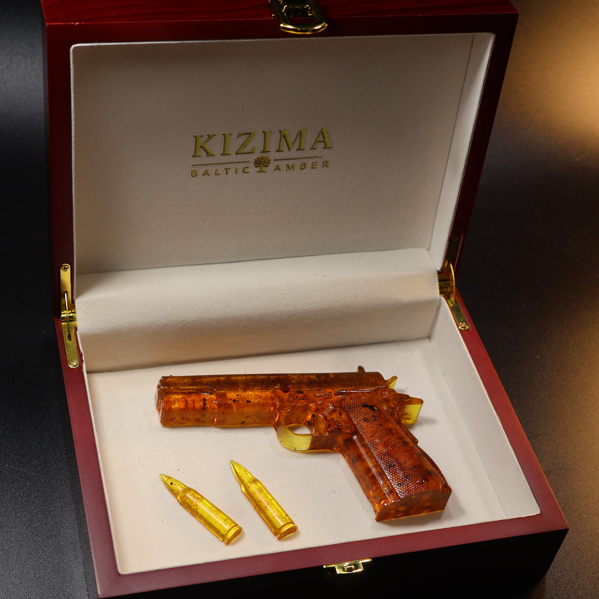 Made in USA Natural Baltic Amber Gun Figurine, Collectible Decor by KIZIMA® — handmade amber pistol sculpture, top view