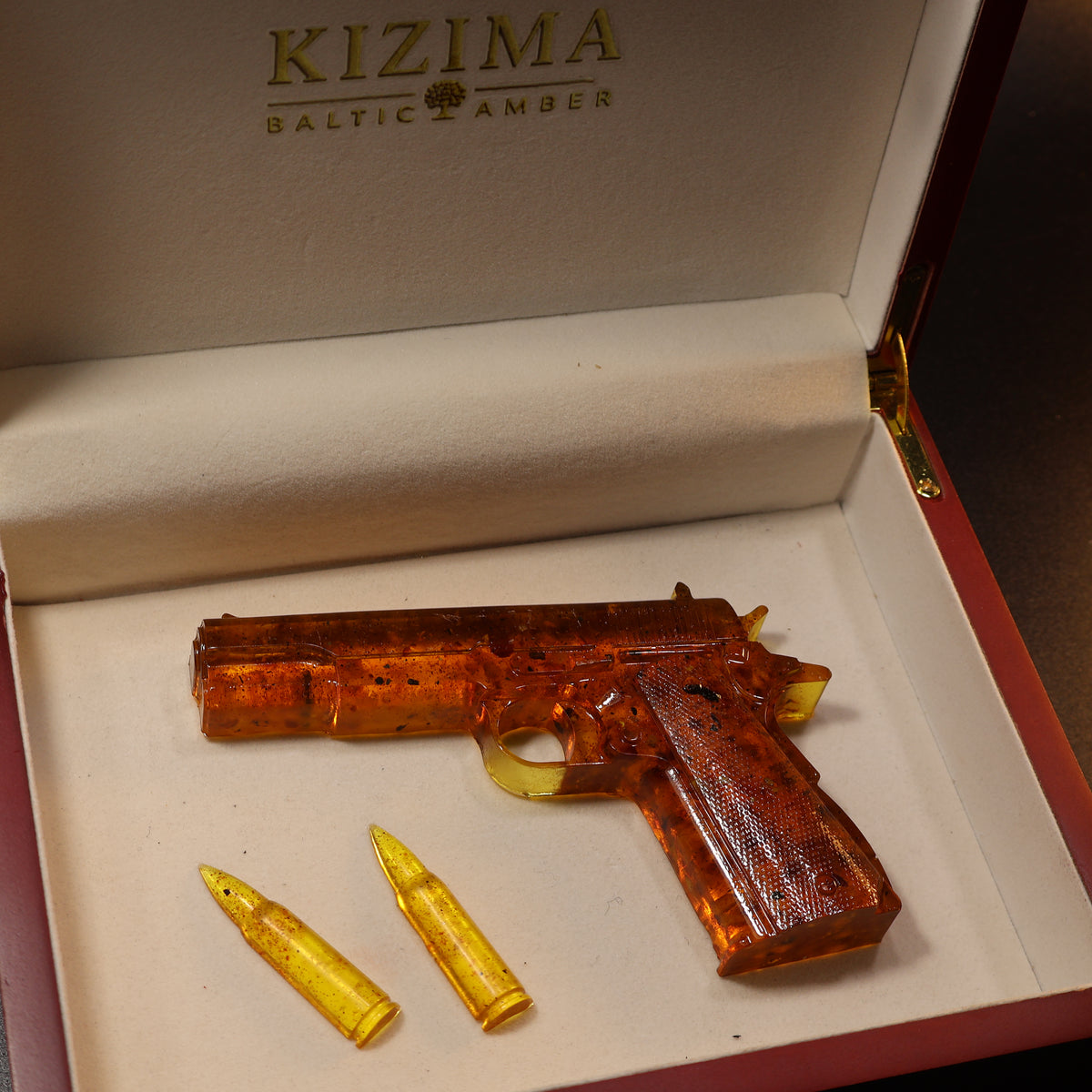 Made in USA Natural Baltic Amber Gun Figurine, Collectible Decor by KIZIMA® — handmade amber pistol sculpture, back view