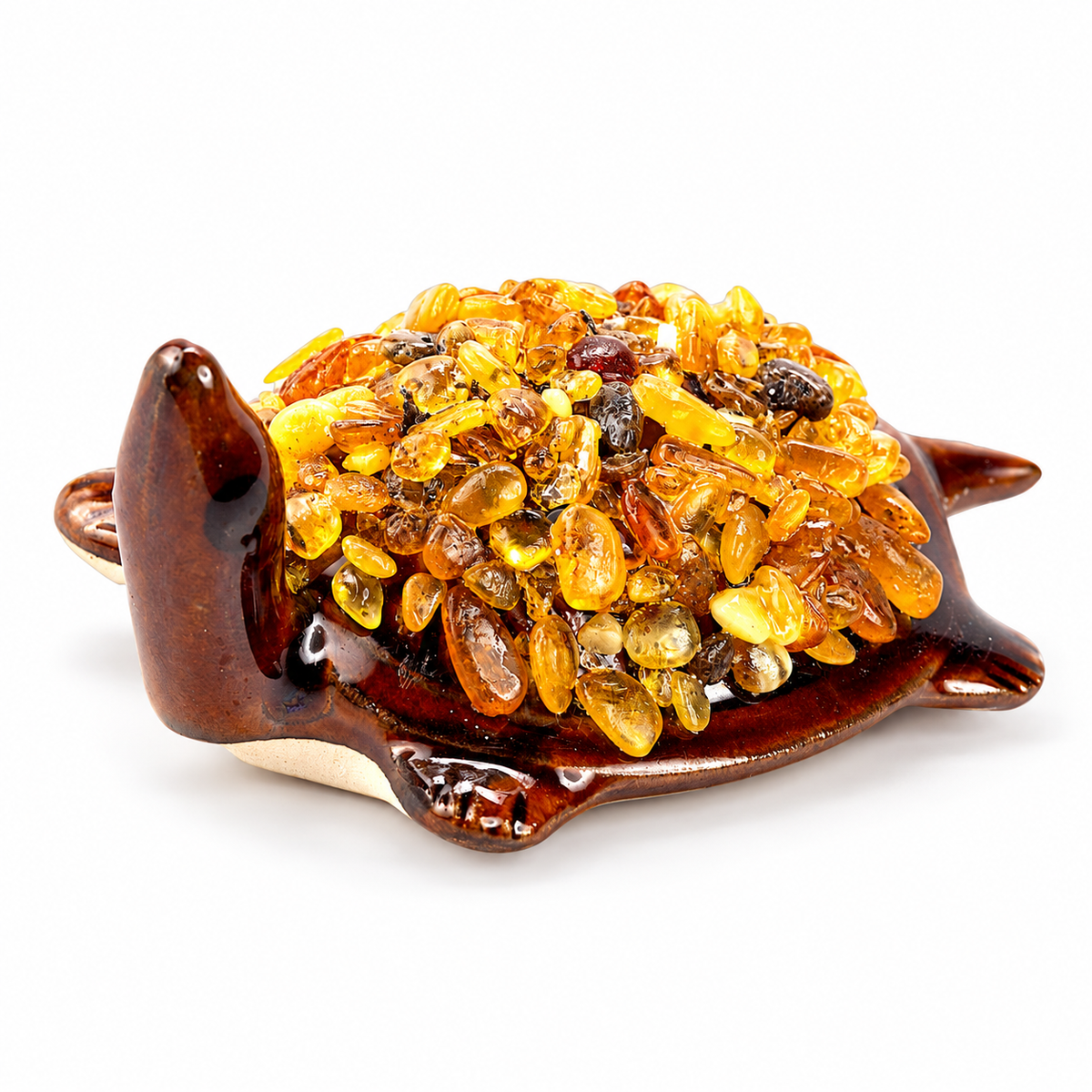 KIZIMA 10N0050q21 Baltic amber turtle figurine on a white studio background, showing the brown ceramic body and natural amber-chip shell.