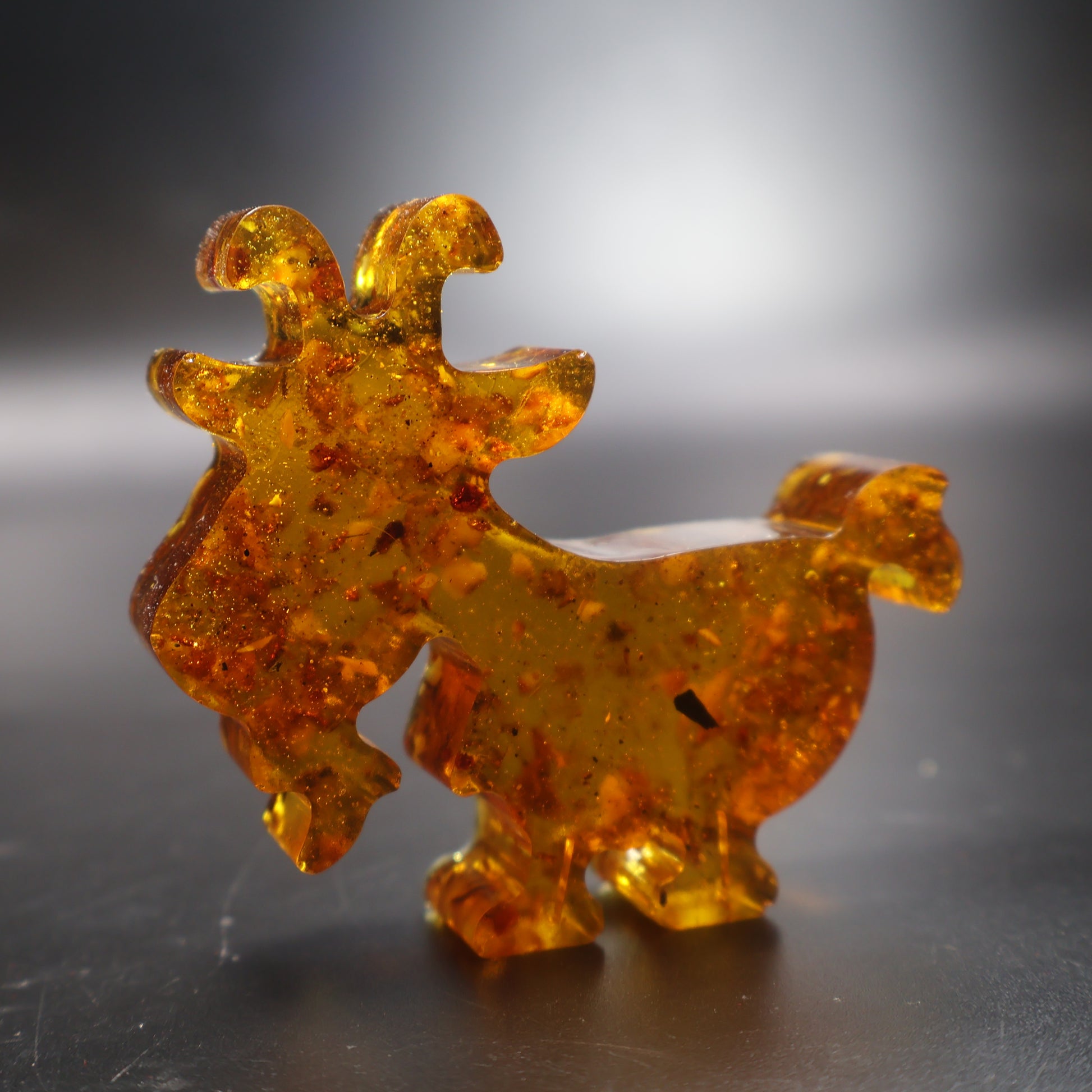 Handcrafted amber goat figurine golden Baltic amber close up