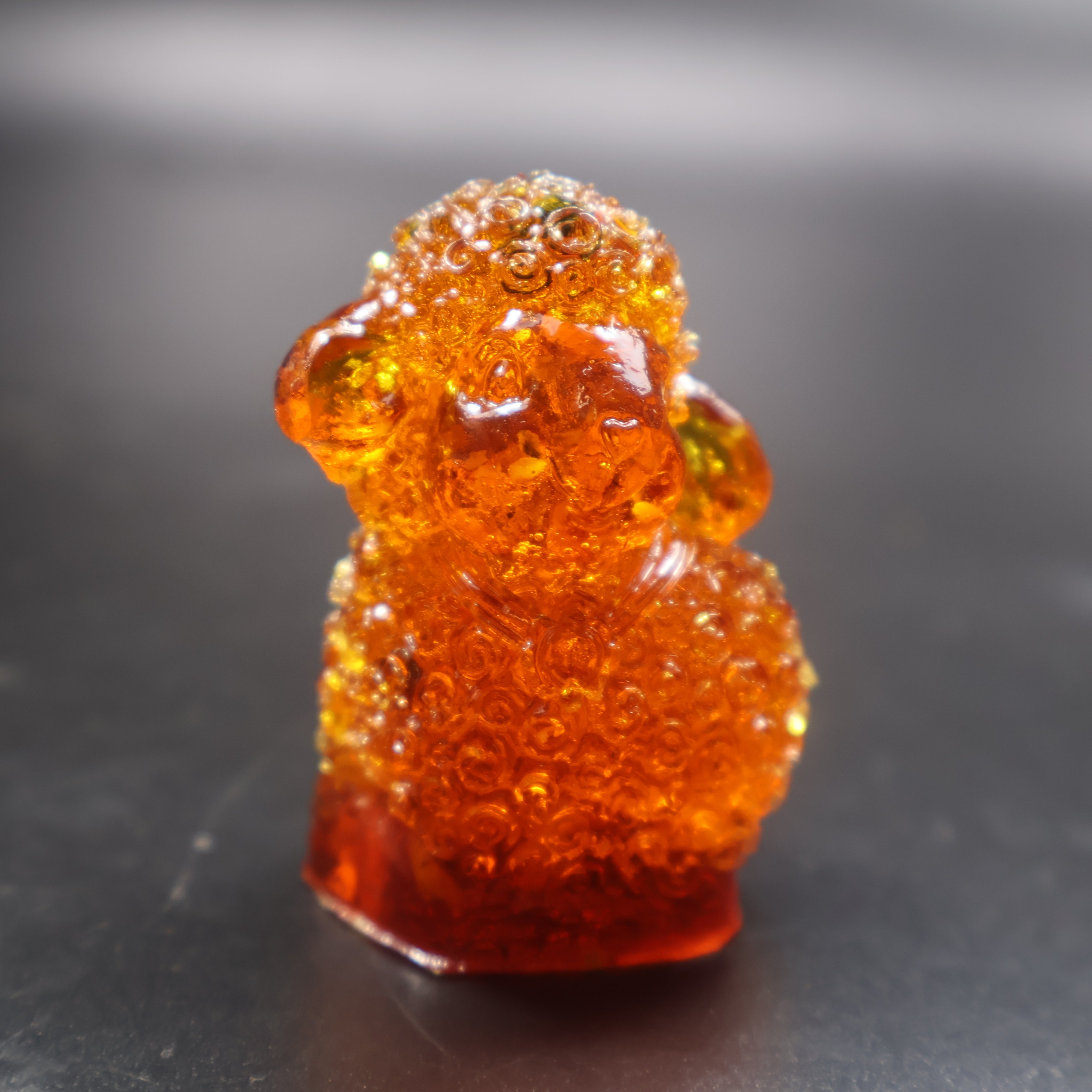 Handcrafted amber lamb figurine golden Baltic amber close up