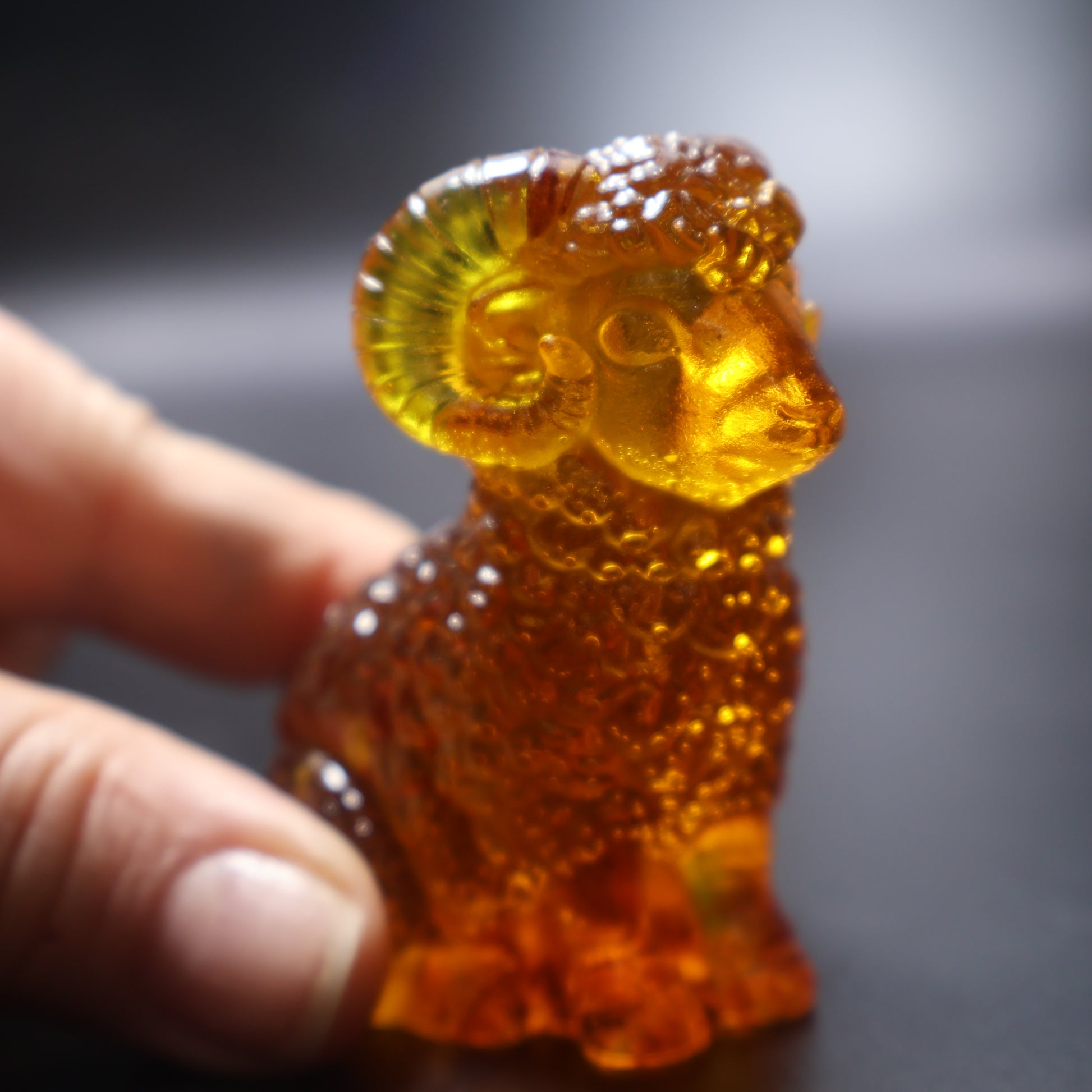 Handcrafted amber ram figurine golden Baltic amber close up