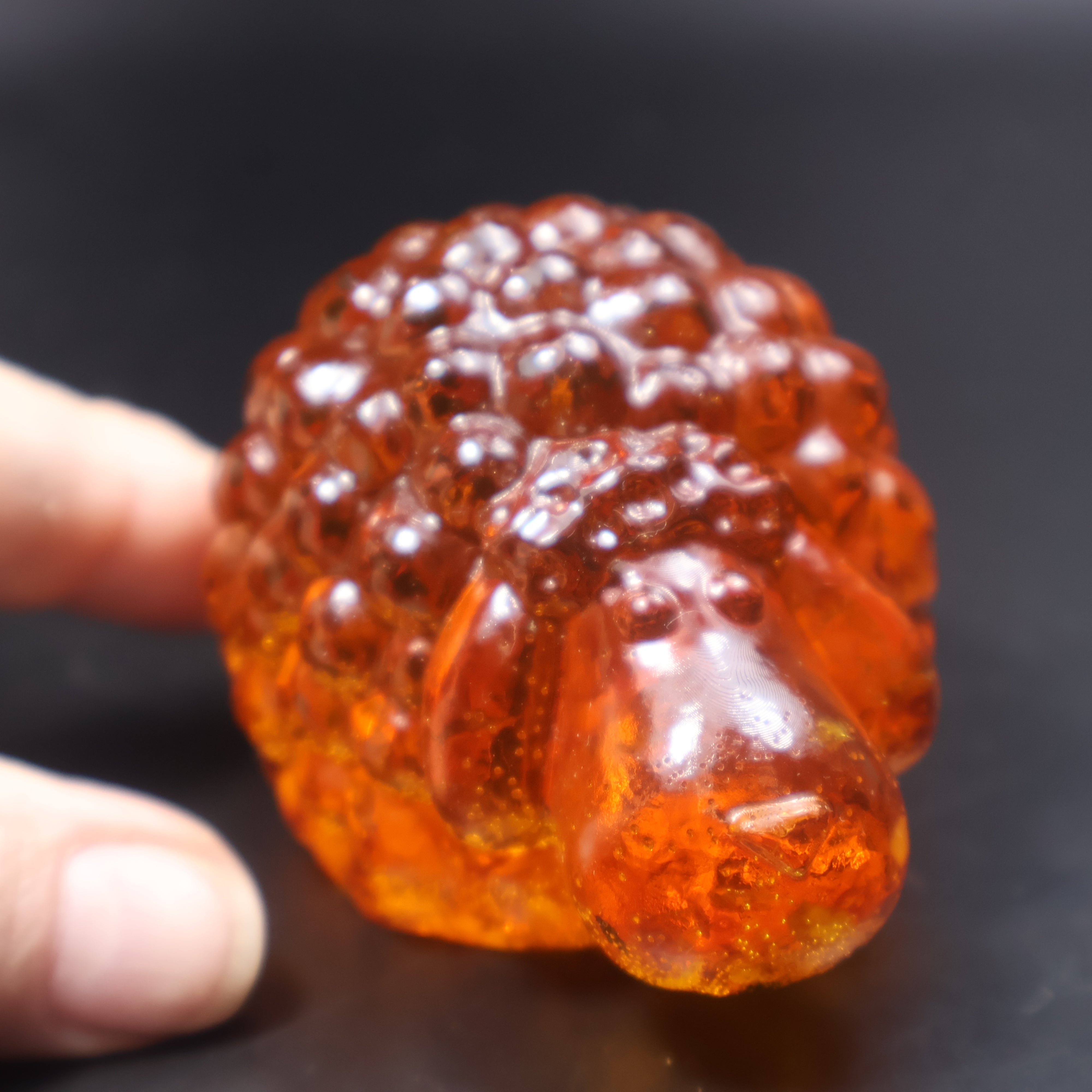 Handcrafted amber sheep figurine golden Baltic amber close up