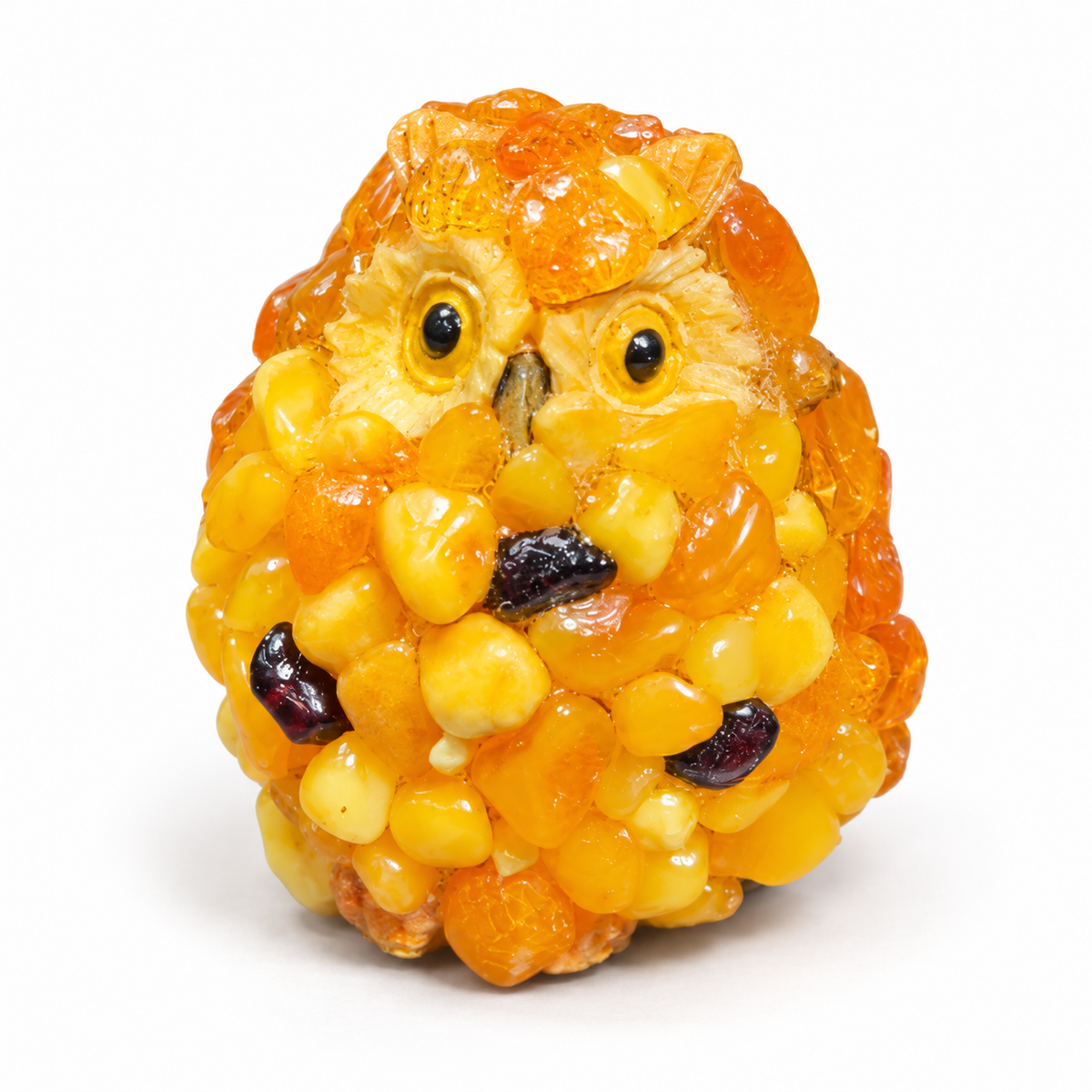 Close-up of the chip-textured amber mini owl figurine on a white studio background.