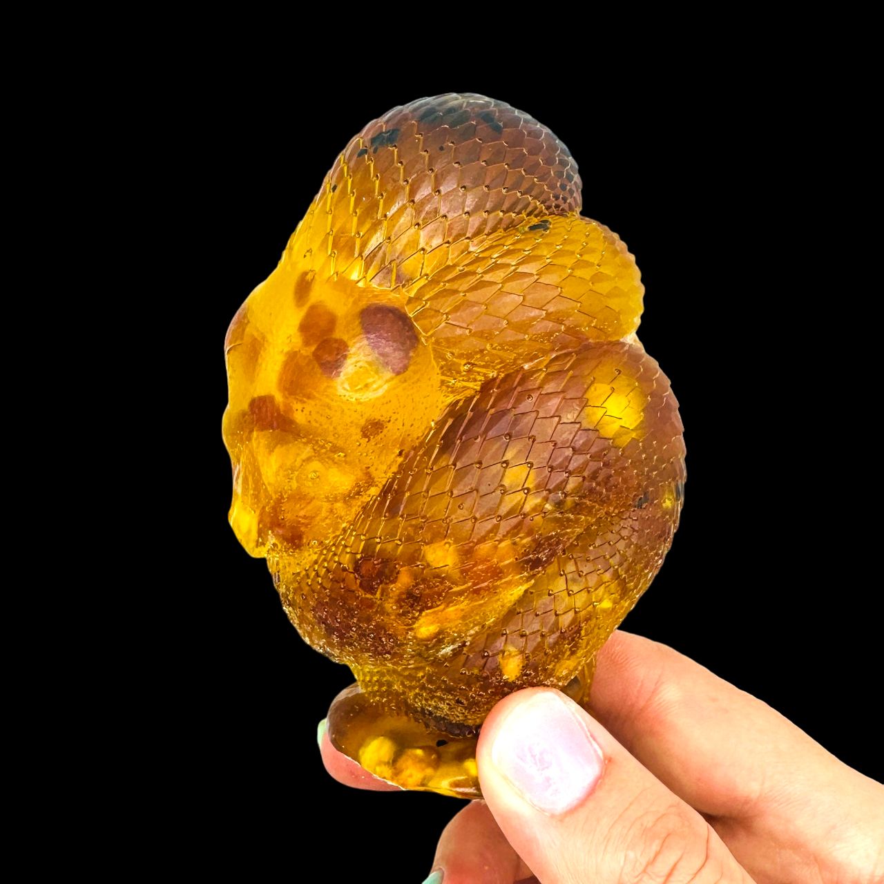 Handmade Baltic amber coiled snake by KIZIMA® USA — natural amber decor, side view